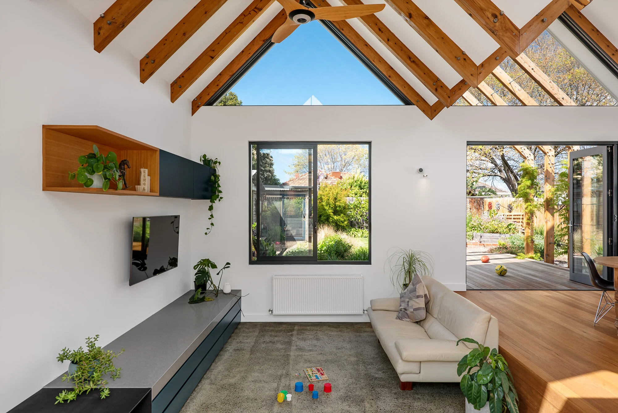 sunken living space with cross ventilation, carpeted flooring, navy cabinetry and garden connection