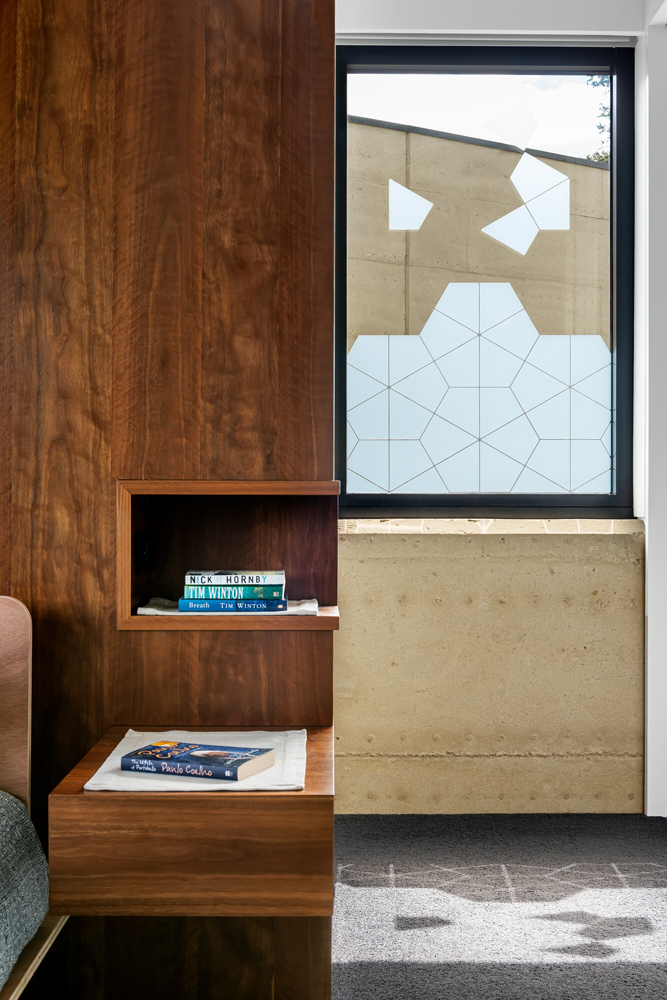 Master bedroom with integrated timber cabinetry wall divider.