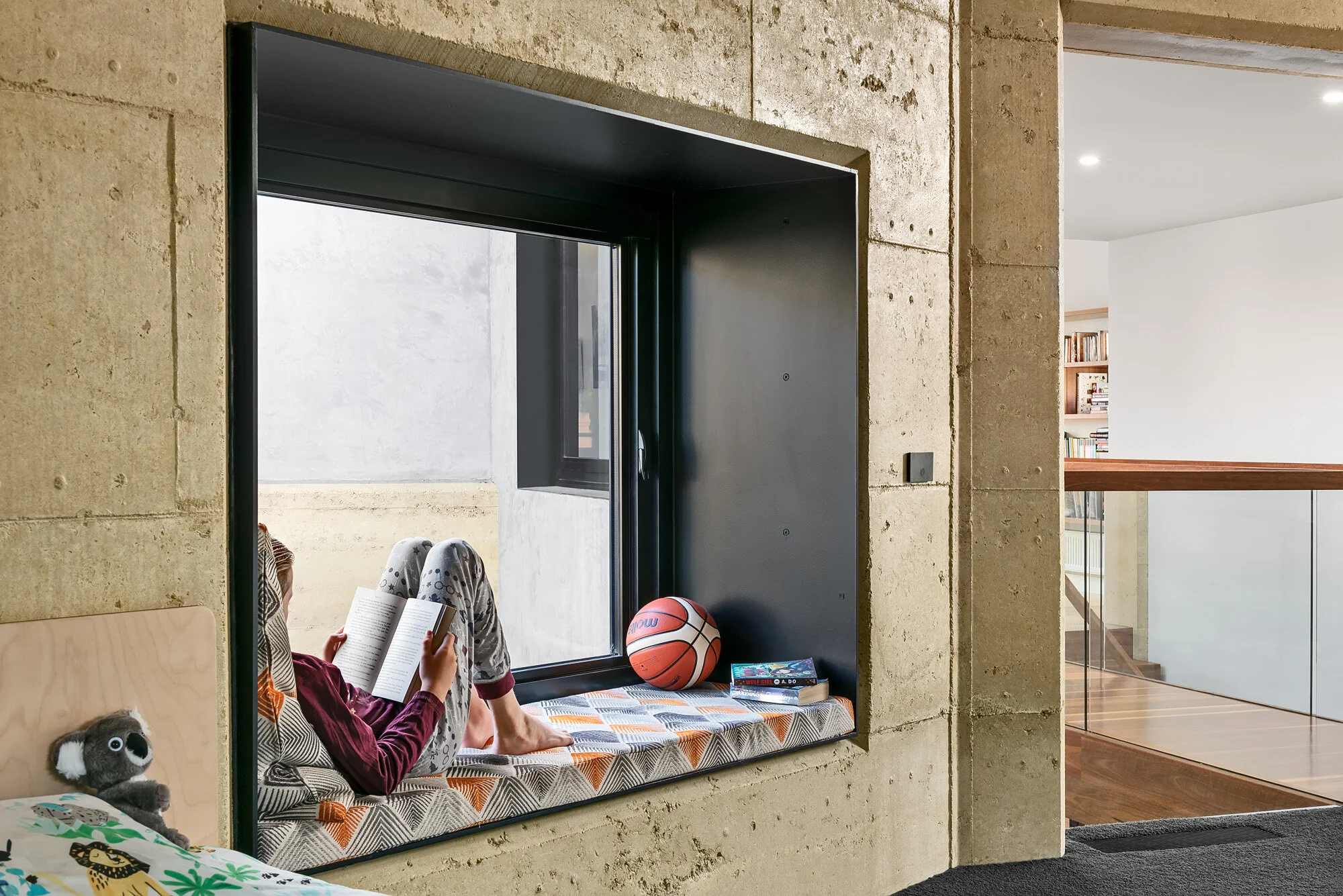 Deep window reveal / seat within rammed earth wall.