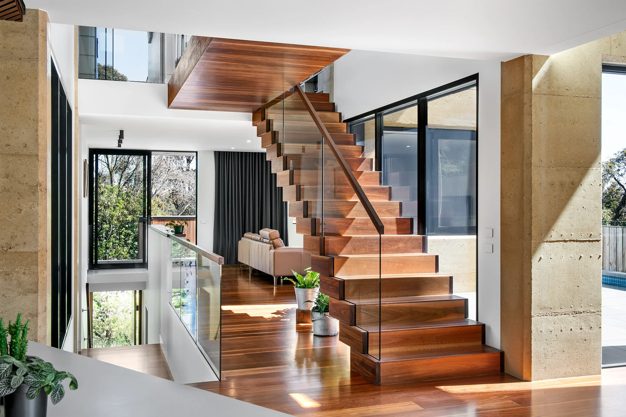 Timber stair detail with views of double and triple height spaces.