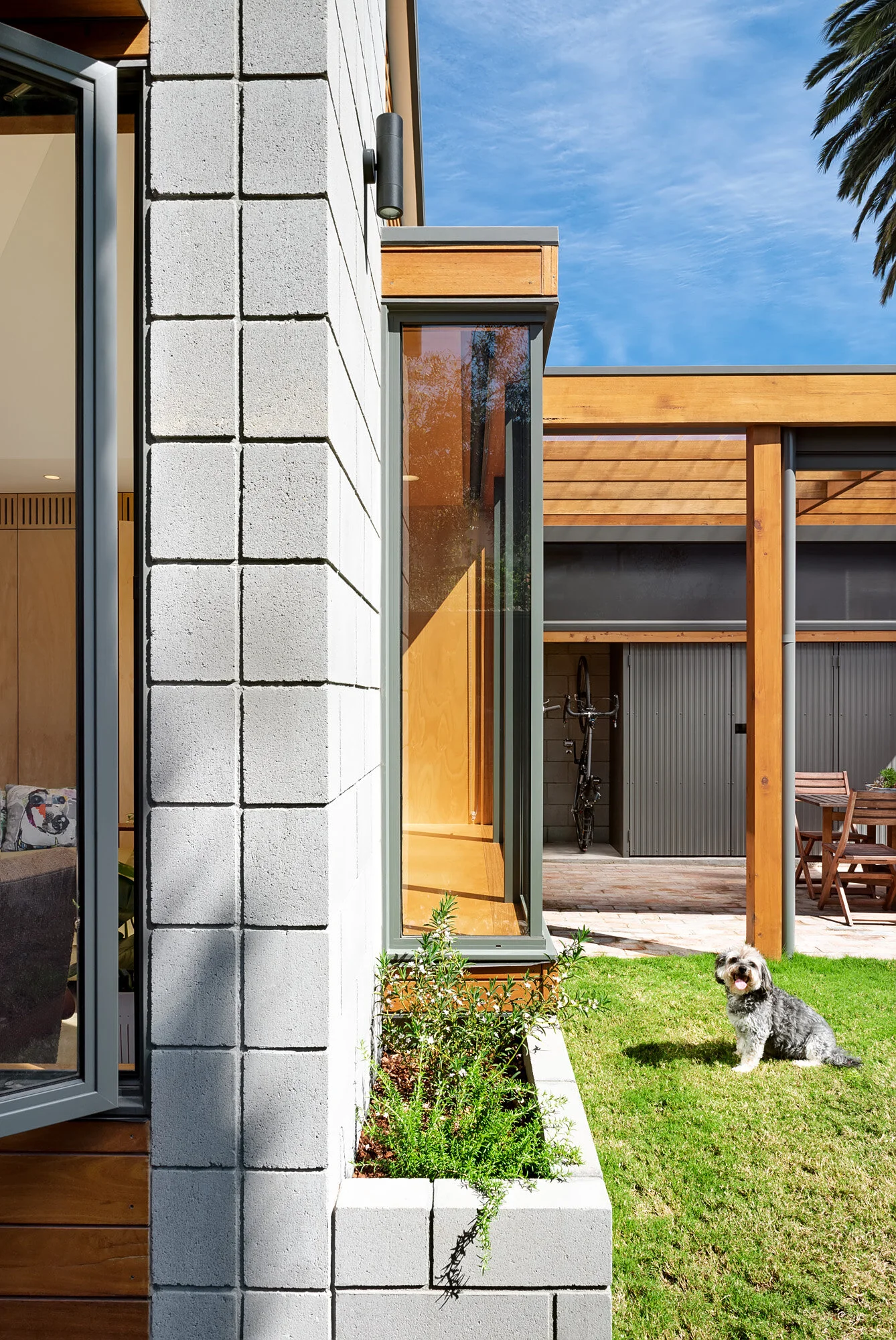 Planter box integrated into concrete block wall. North facing window seat