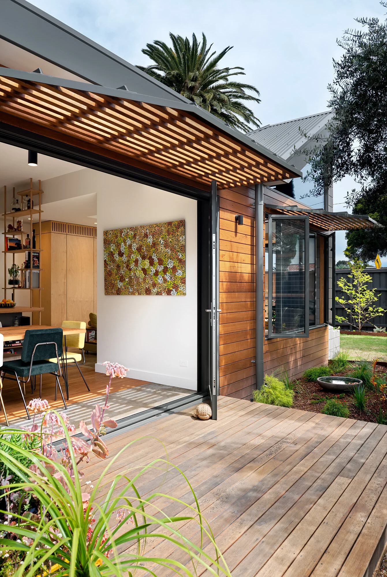Shade hood for passive shading during summer. Shiplap timber cladding to walls
