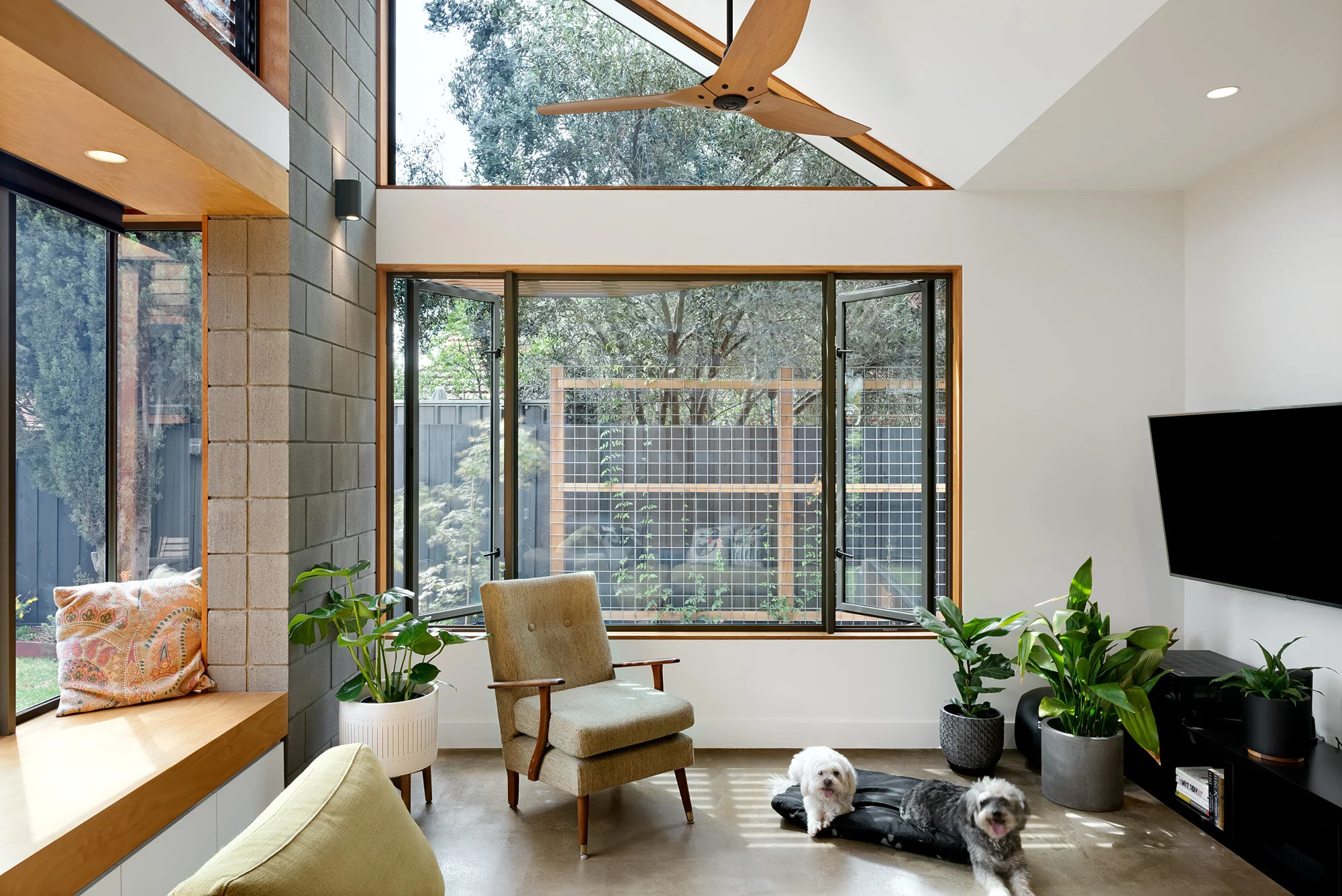 Window seat and casement windows for passive cooling designed by sustainable architect