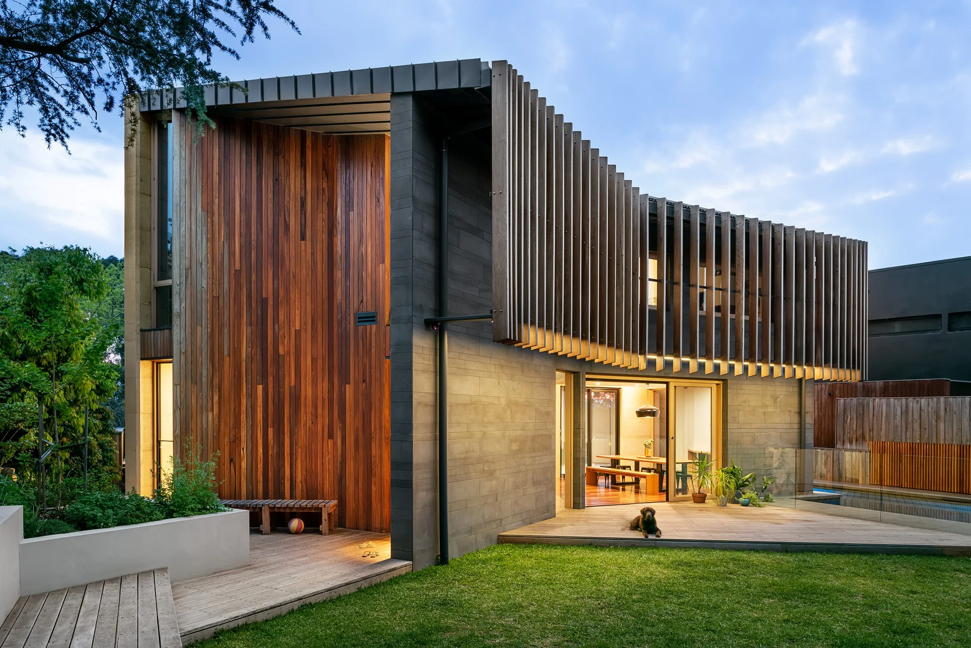 An elegant home with beautiful timber cladding, spacious backyard and lawn with a pool.