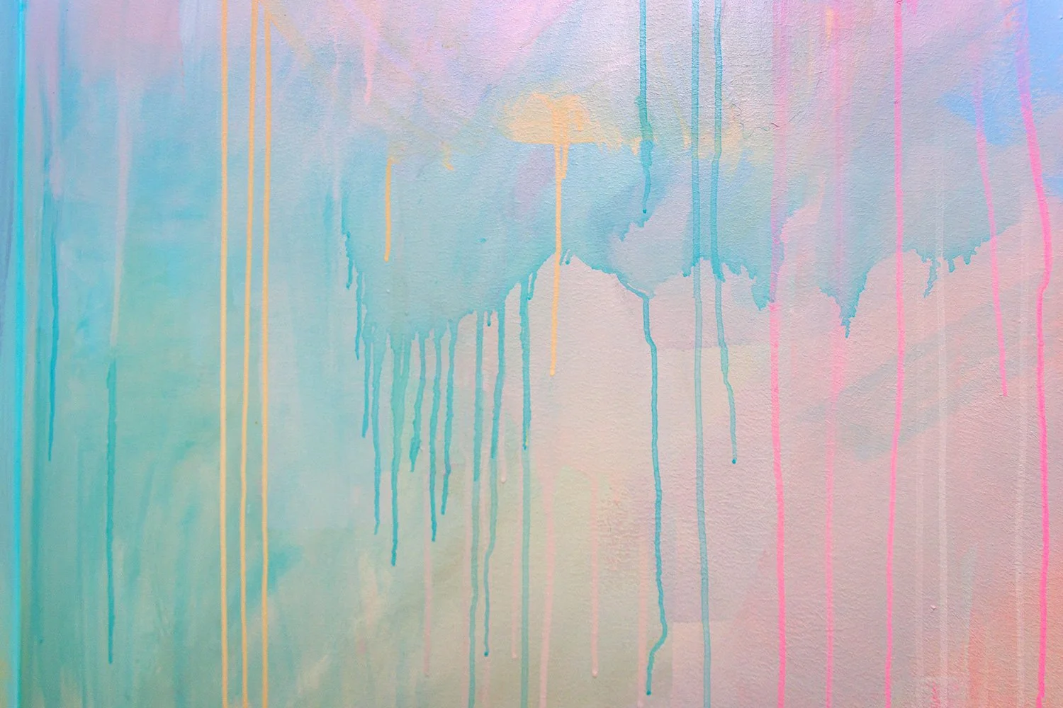 Close up detail of abstract pastel mural featuring dripping paint.