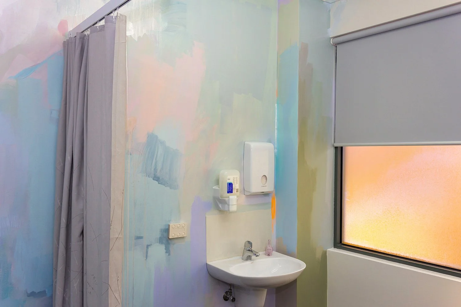 Pastel abstract mural painted in an OB/GYN office, featuring close up of room details.