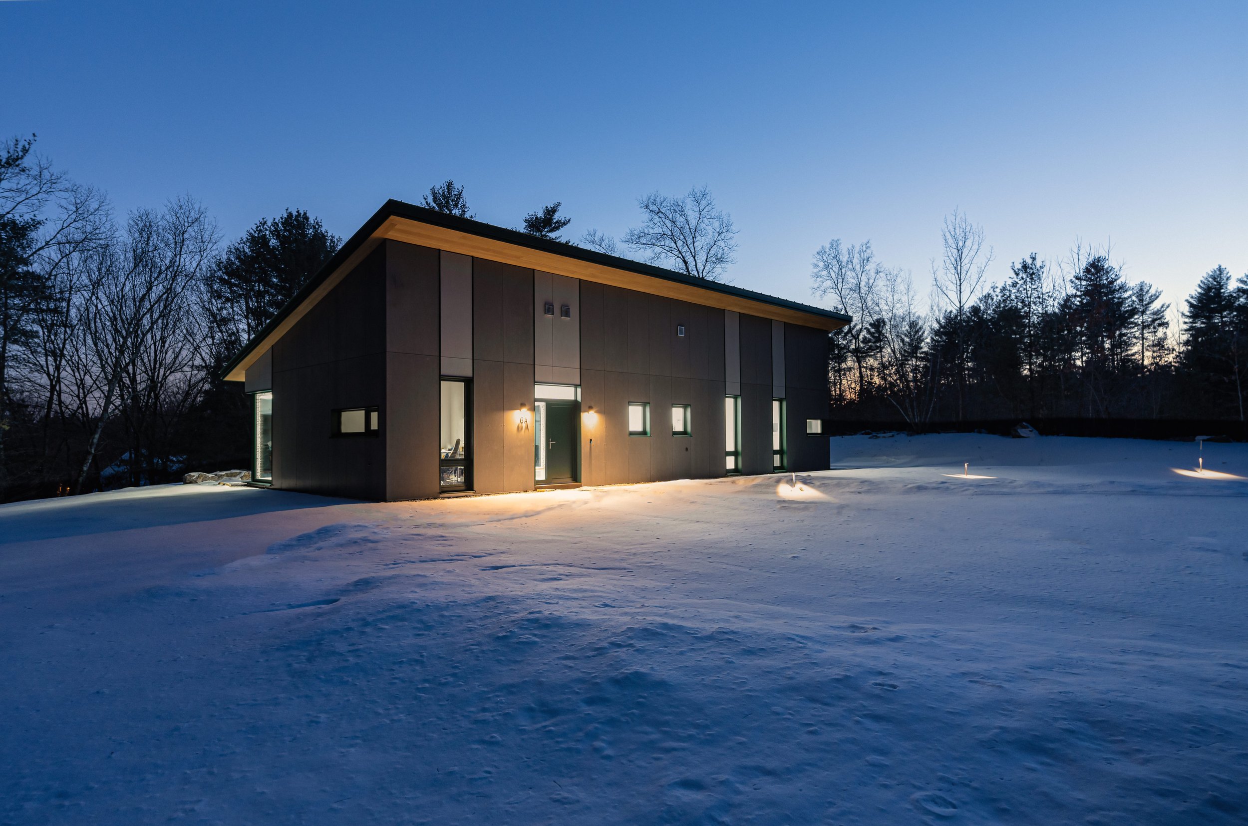 A Passive House lit up at night