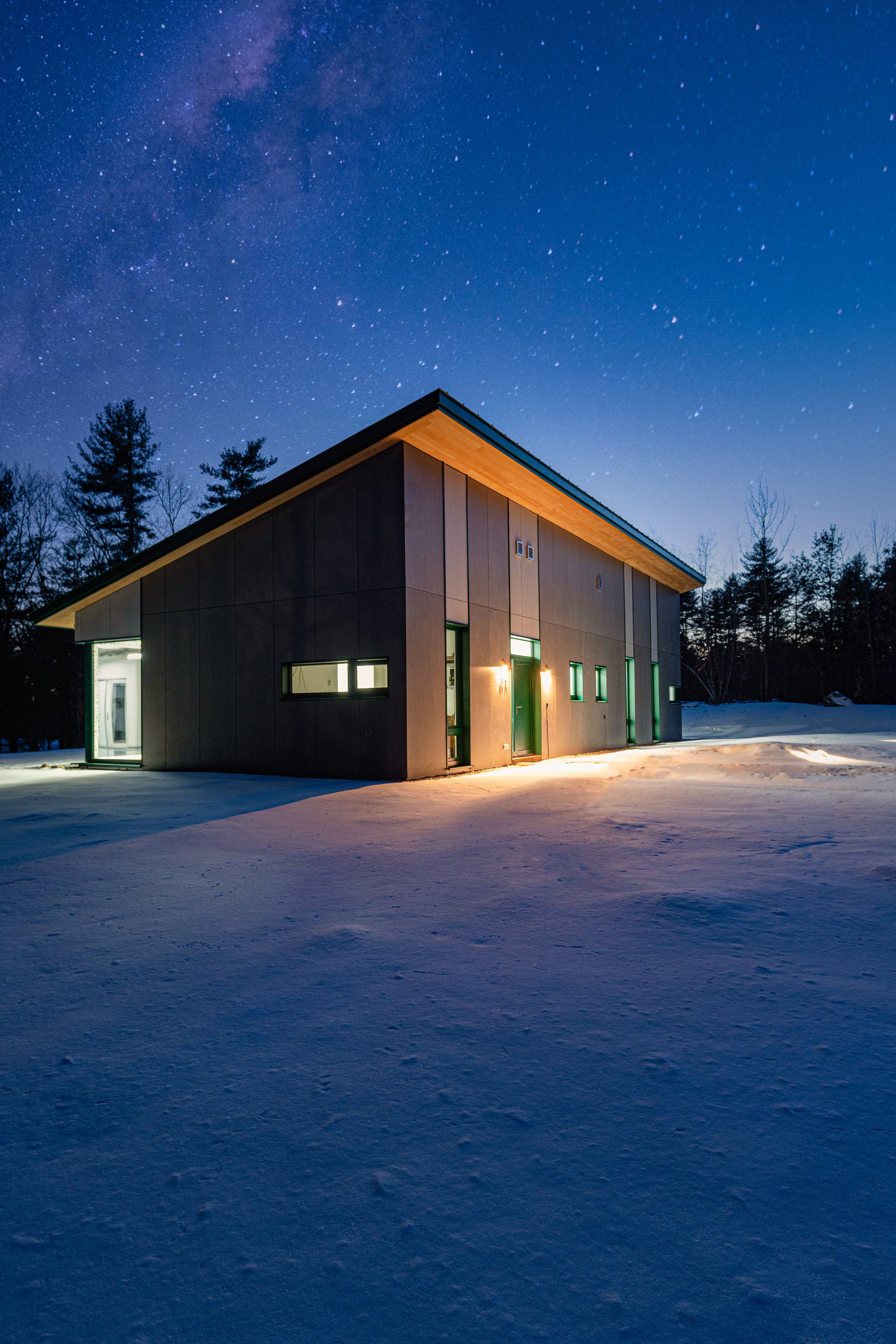 A Passive House lit up at night