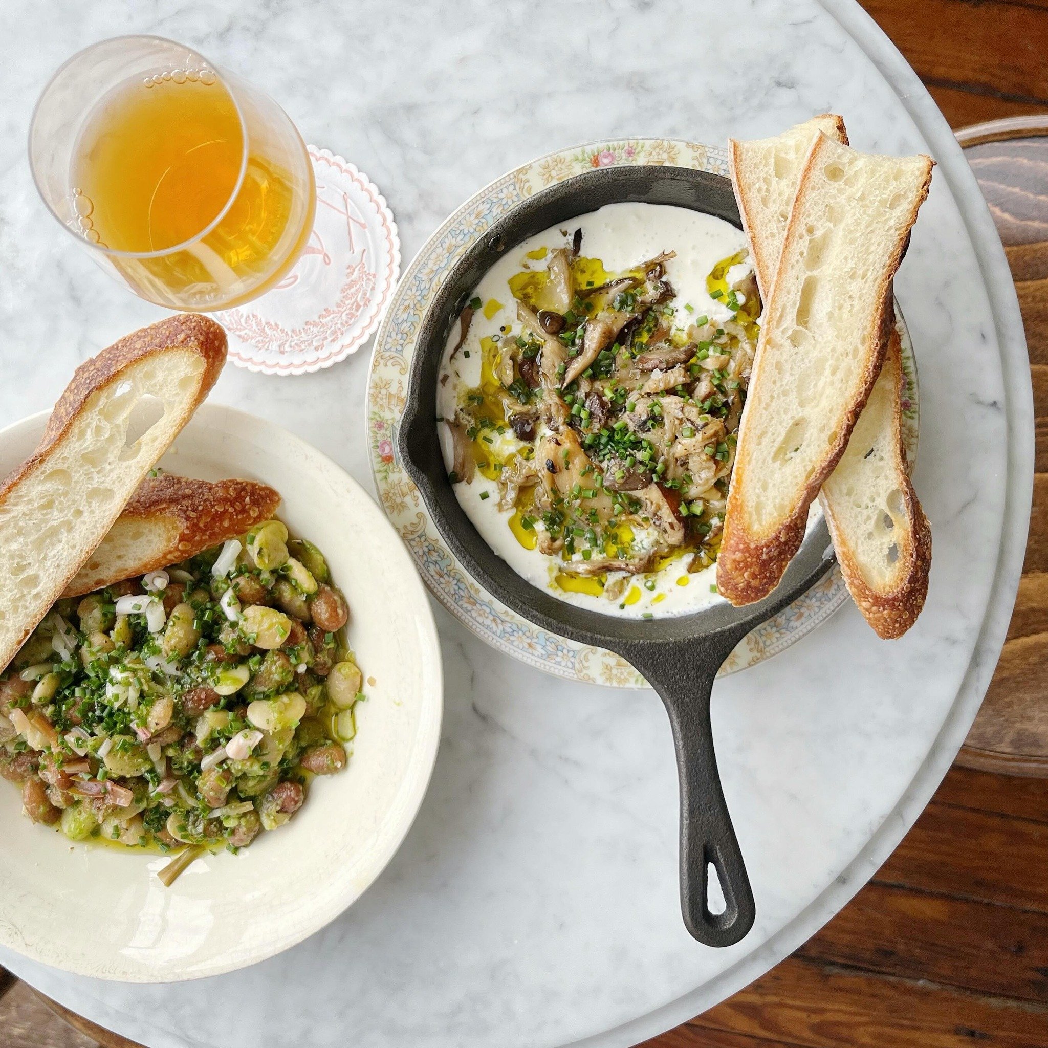 Marinated beans with mint-ramp pesto + pickled ramps / Mushroom conserva with whipped ricotta / @rosiegeneral baguette to top it all off 👑