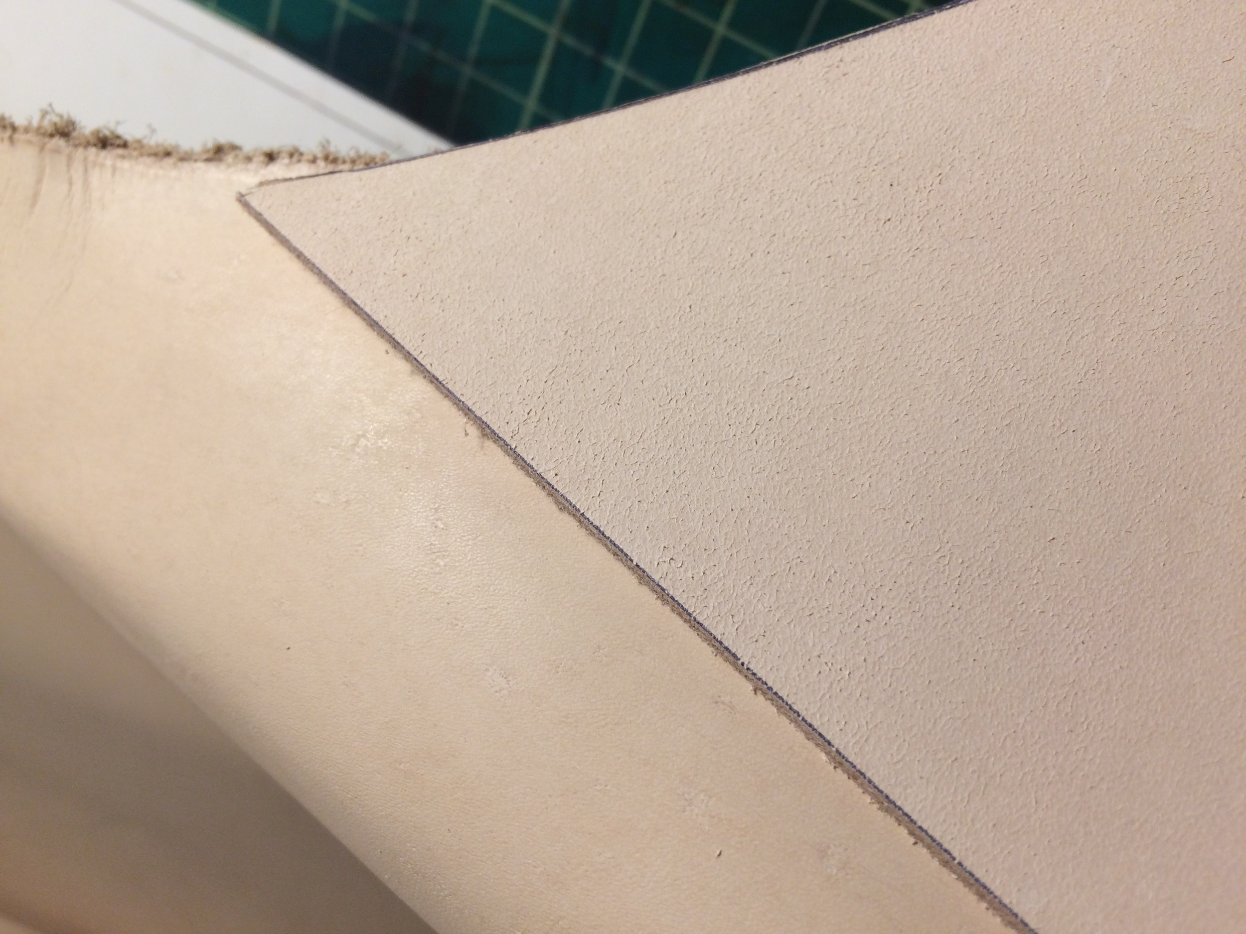 This is the topside of two different pieces of leather. The one on the left looks as it should, while the one on the right almost looks like its the underside due to how coarse it is.