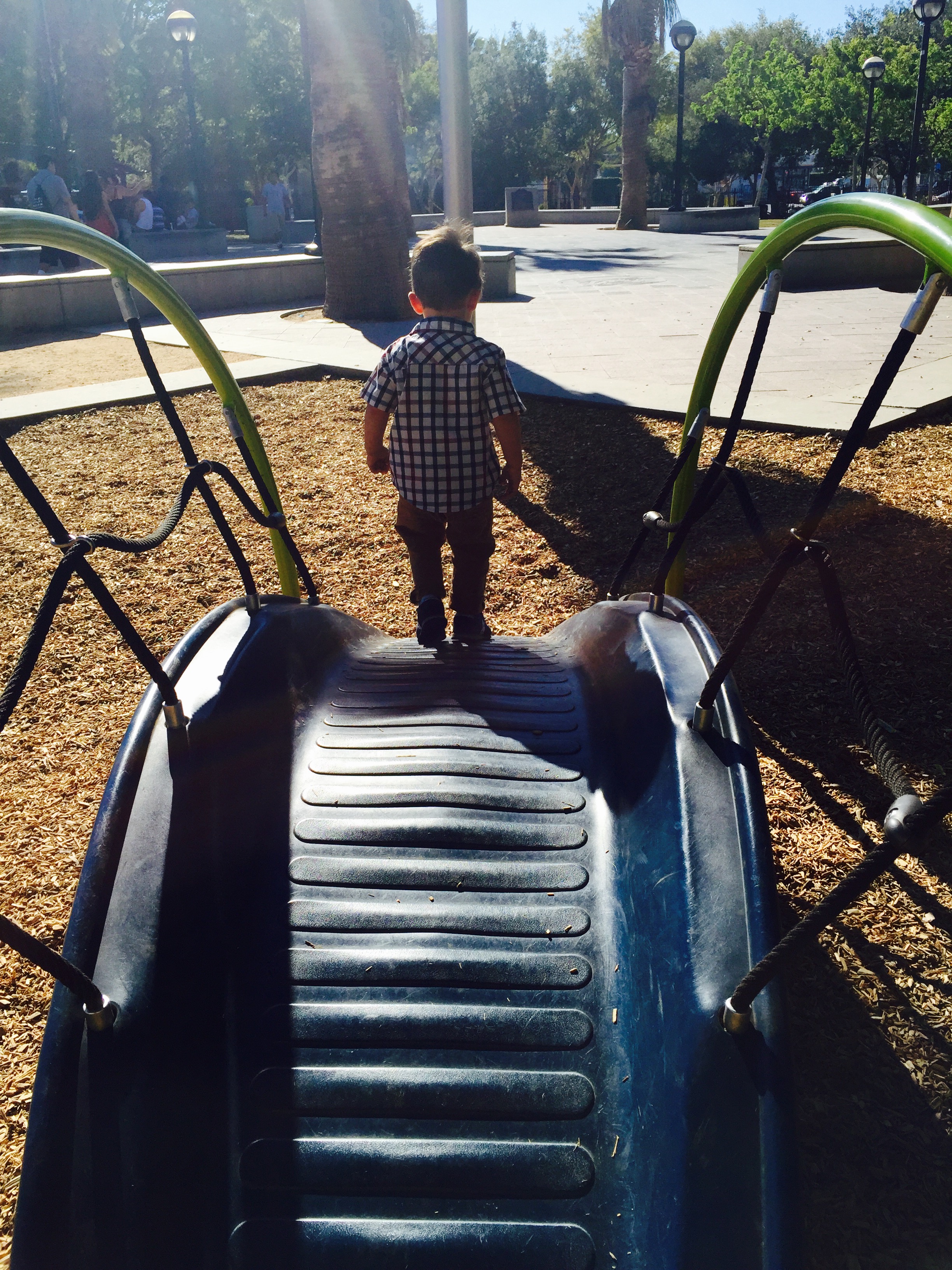 toy bridge to more wood chips. kid does not care. kid loves wood chips, to mama's dismay.