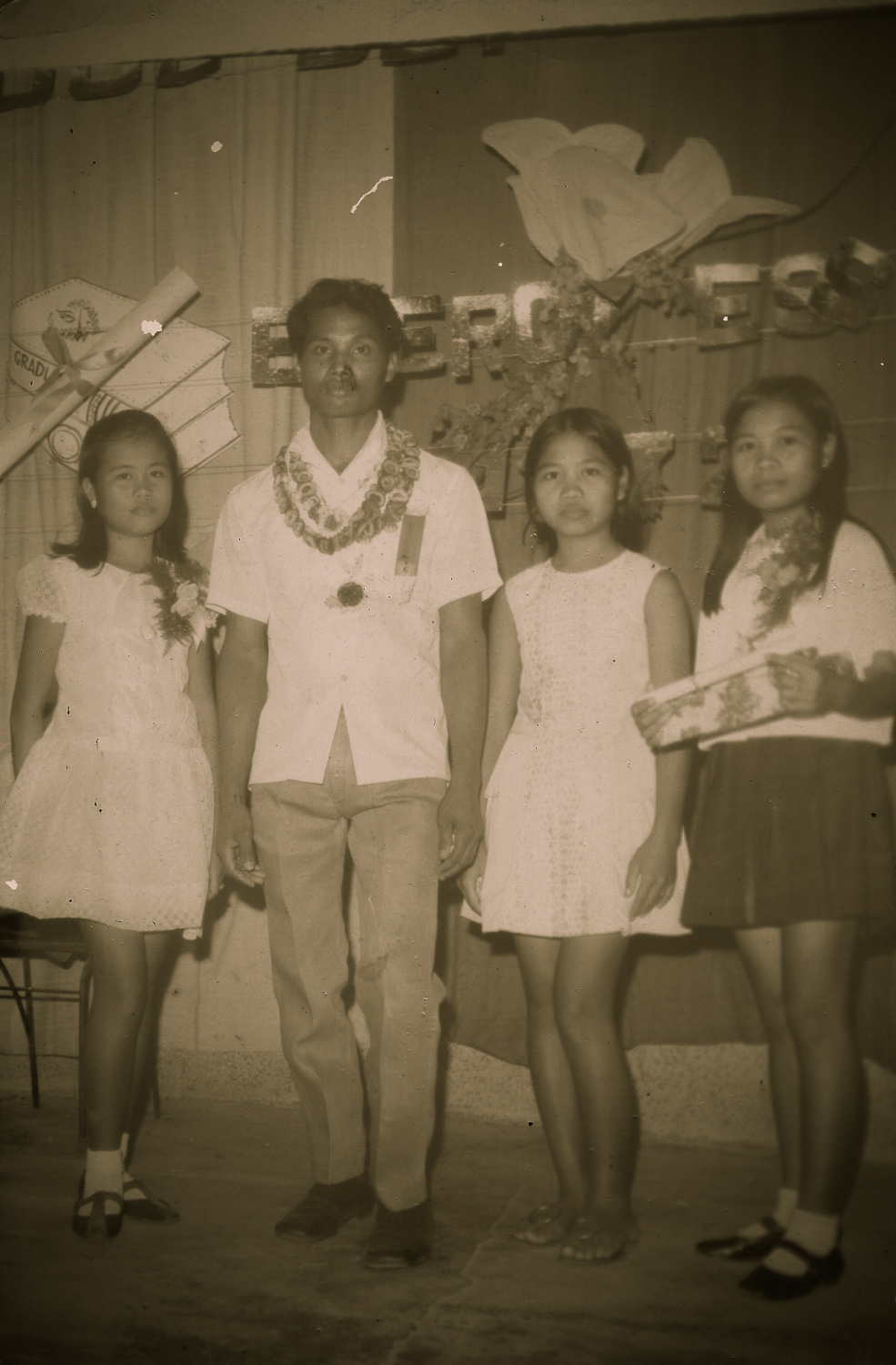 My three sisters Ate Grace (Left), Ate Del (Centre) and Ate May (Right). There were in their early teens. I don't know who the dude was though, I don't care about him.