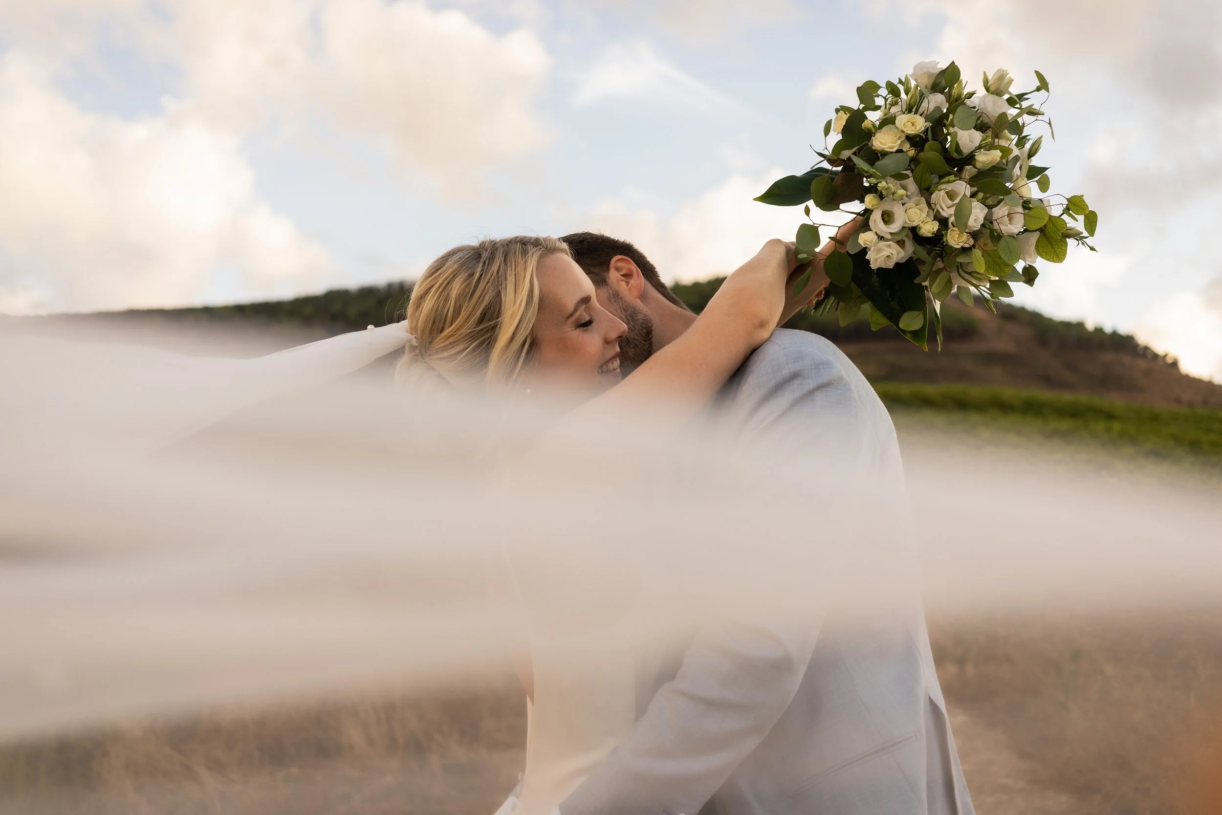 real hug between bride and groom just married in Baglio Strafalcello