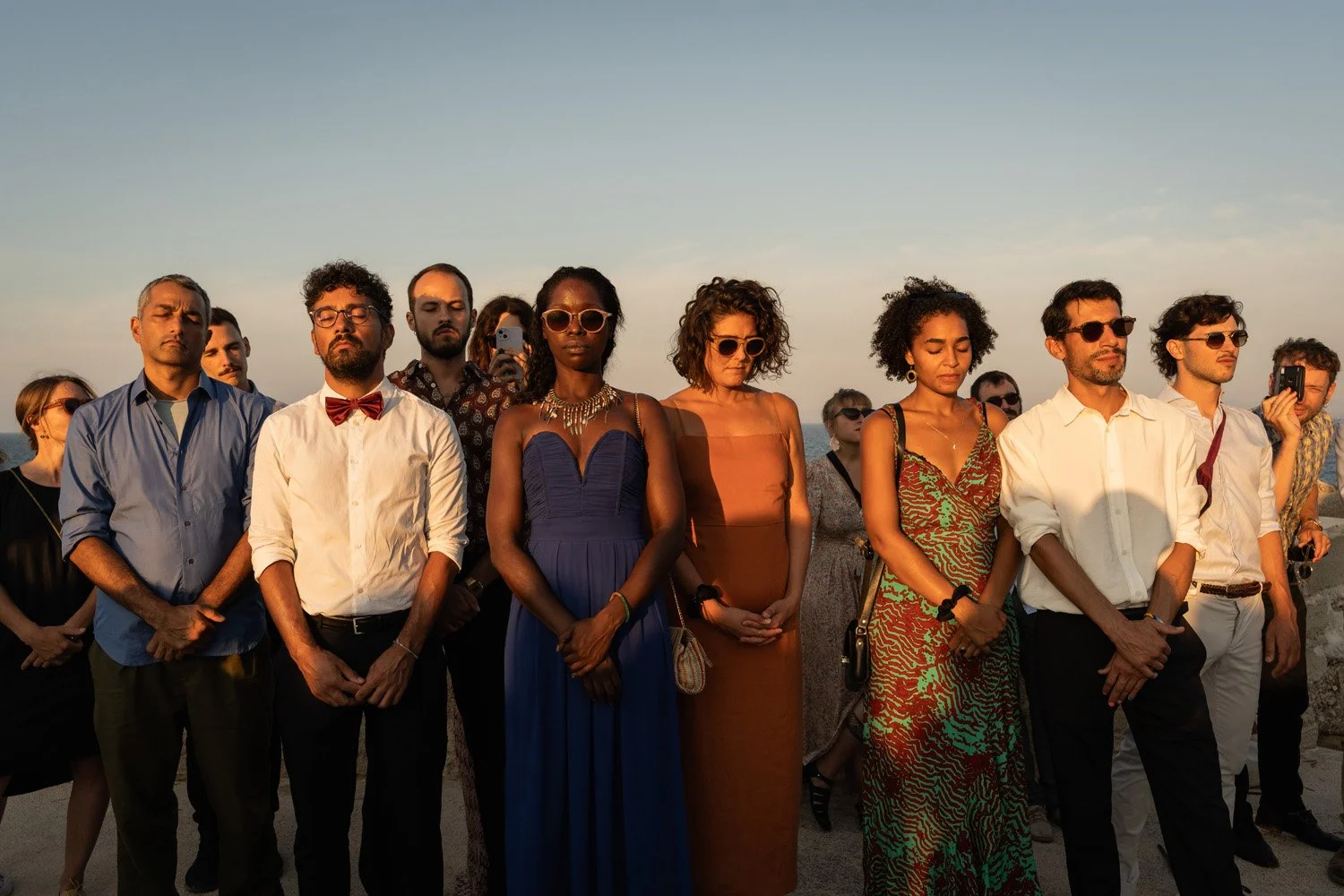 Guests at Favignana's wedding with sunset light
