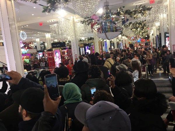 Demonstrators flood the entryway of Macy's on Friday morning, November 25, 2016.