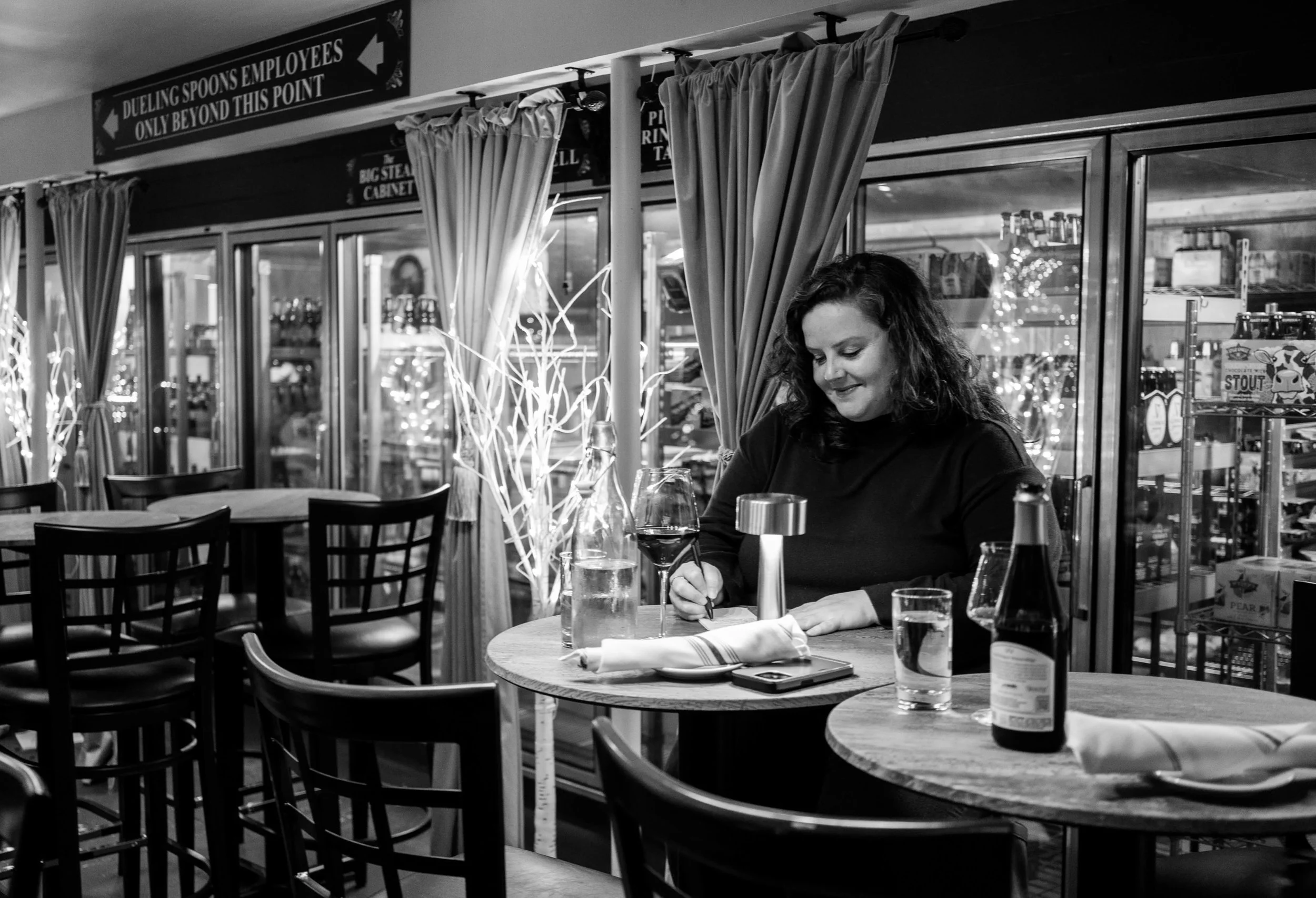 Woman writing in restaurant.jpeg