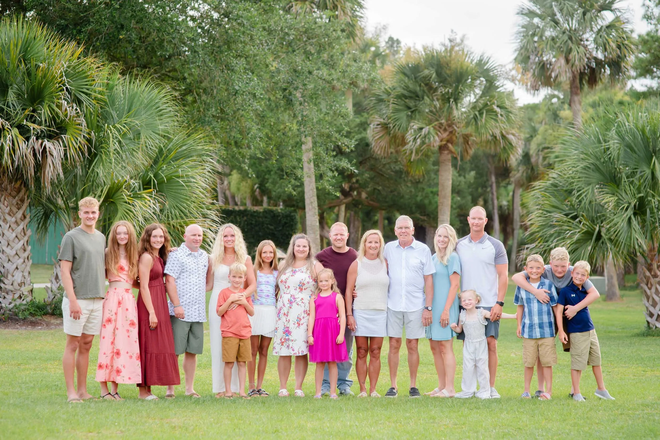  Extended family session at Huntington Beach State Park SC with historic stone structure and palm trees backdrop 