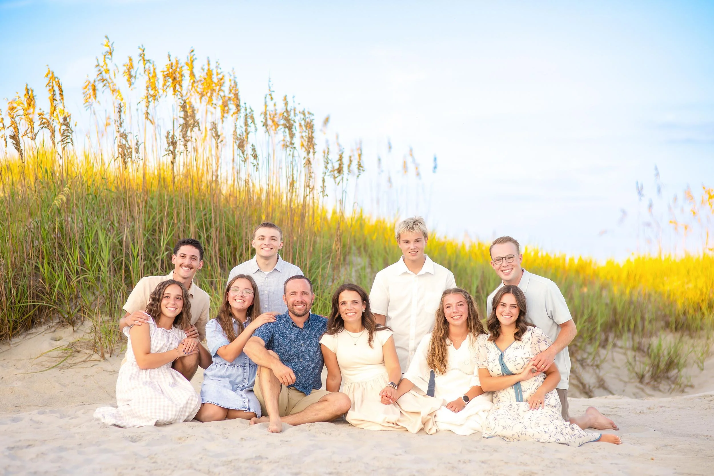 extended-family-beach-portrait-sitting-dunes.jpg