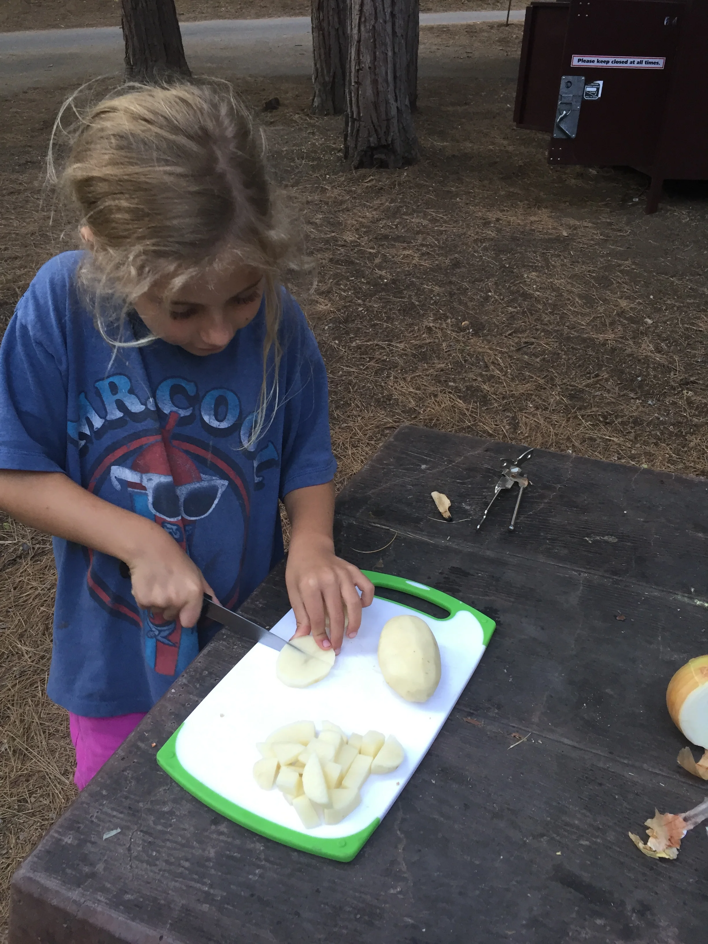 Rowyn was our potato cuber, Cole was our potato peeler. (Logan was probably poking at the fire with a stick.)