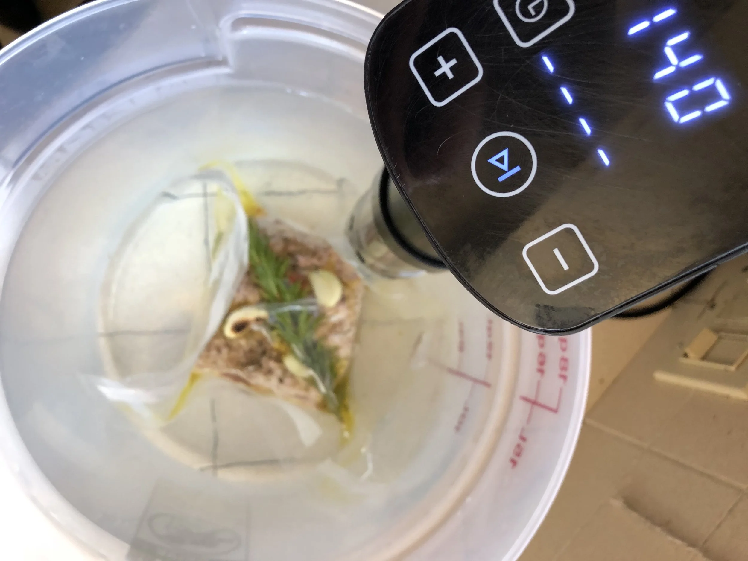  Sous - vide (/suːˈviːd/; French for "under vacuum") is a method of cooking in which food is placed in a plastic pouch or a glass jar and then placed in a water bath or steam environment for longer than normal cooking times (usually 1 to 7 hours, up to 48 or more in some cases) at an accurately regulated temperature.