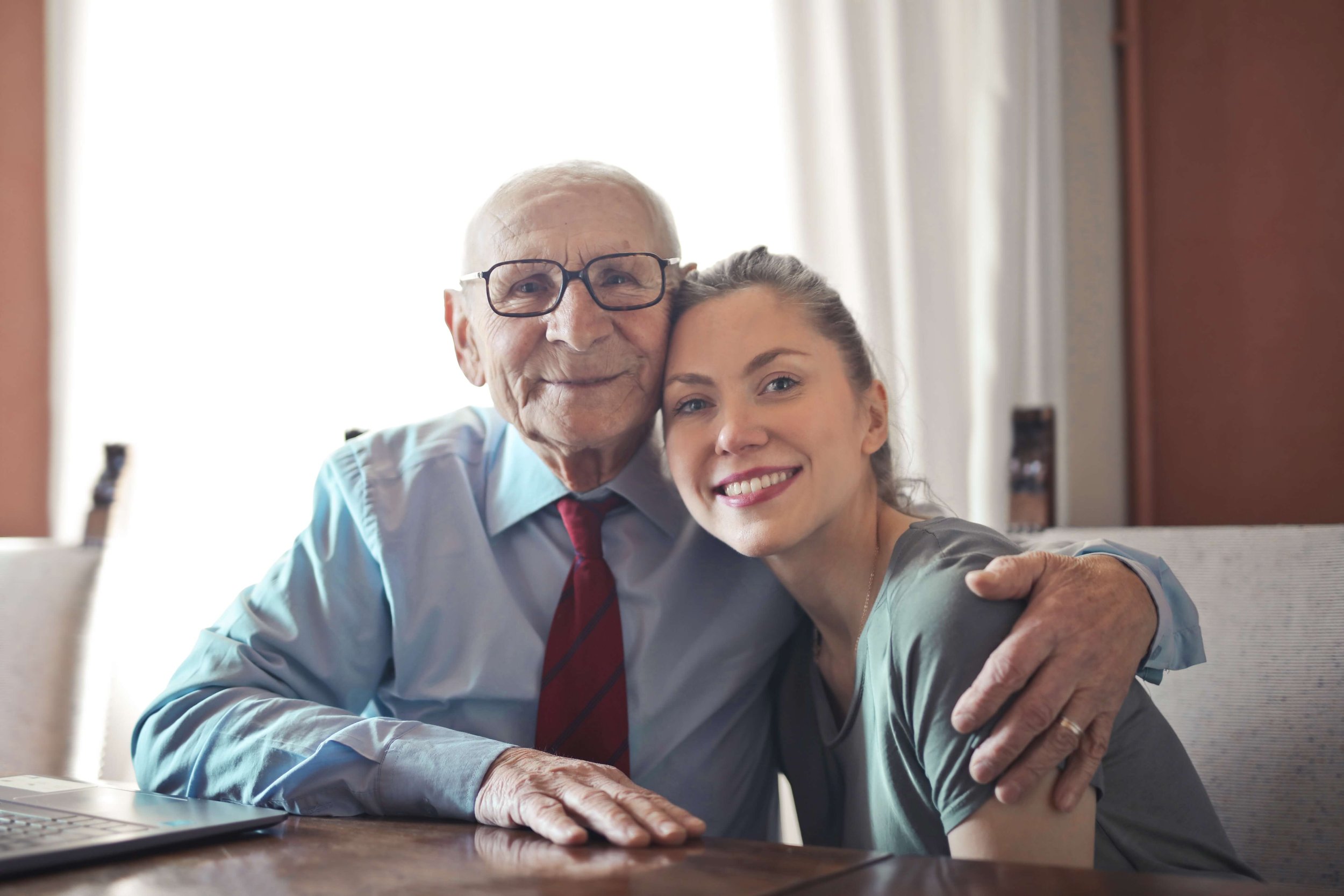 A young woman sits with her grandfather representing the role changes as you transition to adulthood. Connect with a Young Adult Therapist to navigate these changes.