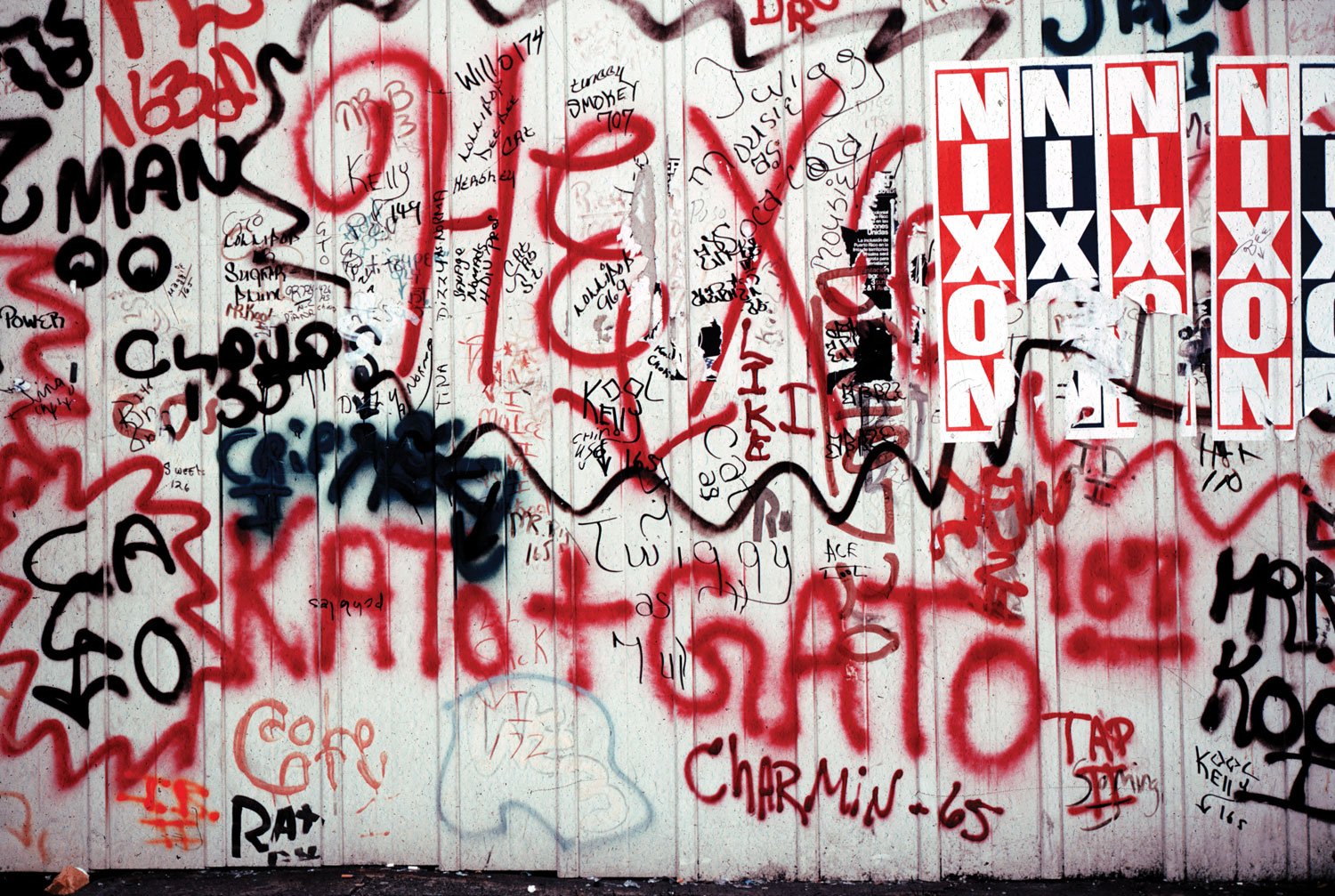 Wall in the Bronx featuring Nixon posters and a CHARMIN 65 tag.