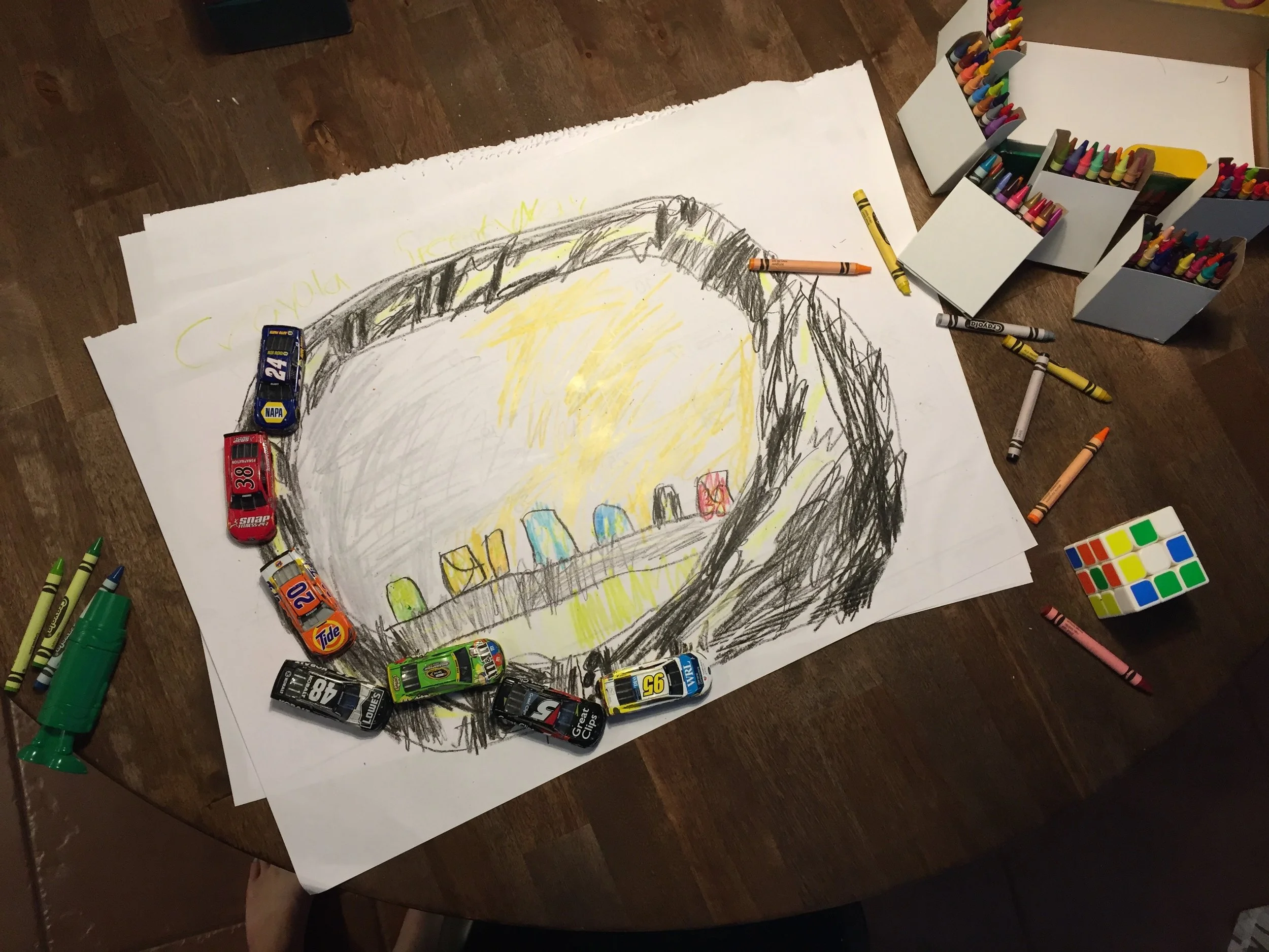 Morning 1: He pulled out his crayons and drew a racetrack for his cars to drive on. Then it started to rain outside and he sat on our porch to watch the storm roll in. 