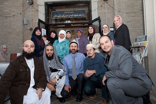 Members of the Center, a Sunni Mosque, gather on Hispanic Muslim Day at the entrance to the building. Photo by Christopher Lane.