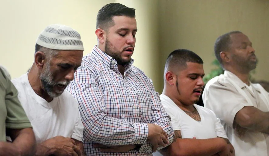 Alex Gutierrez, second from left, prays during Friday prayers in the mosque at the Islam in Spanish Centro Islamico, Friday, Aug. 5, 2016, in Houston. Gutierrez, the director of development and operations, was raised Catholic, but he has been a Muslim for 12 years. In its first months, Centro Islamico welcomed 28 new converts to Islam, said Gutierrez, Islam in Spanish's development and operations director. "They were all Latinos — families, single mothers, couples with children. We've had 10-year-old sisters; we've witnessed a grandmother accepting Islam." (Jon Shapley/Houston Chronicle via AP)