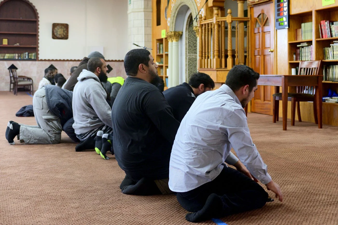 Jalil Navarro, right, and Iman Isa Parada, next to him, take part in the afternoon prayer at Masjid al-Hidaya mosque, in North Philadelphia on April 27, 2019.