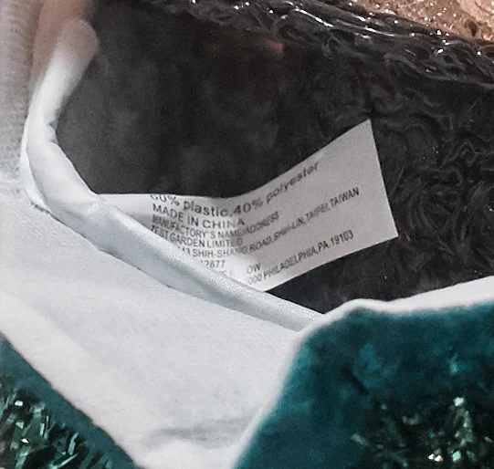 You can still read the following: 60% plastic, 40% polyester MADE IN CHINA