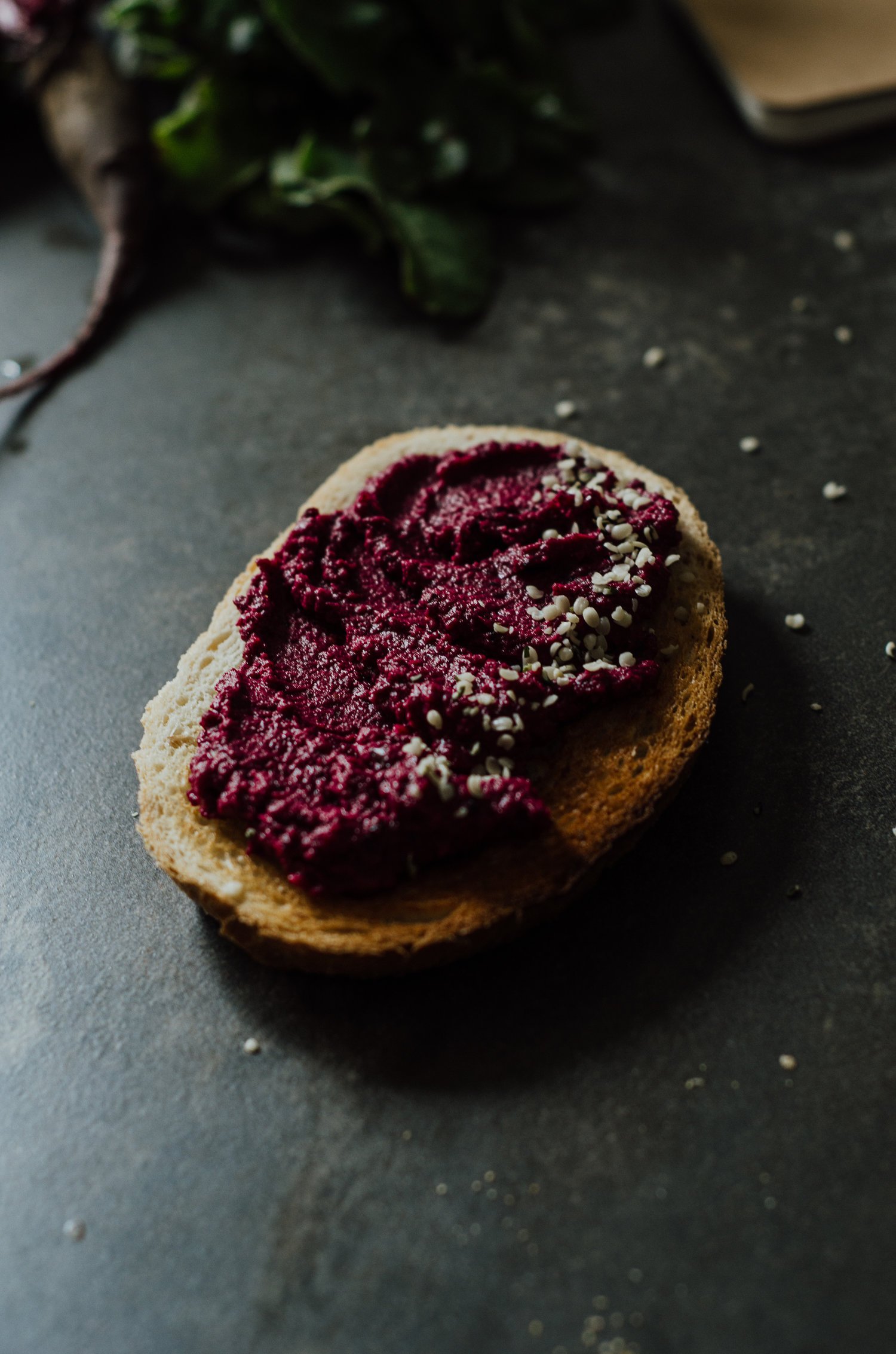  A pice of toast with haskap hummus spread on the top. 