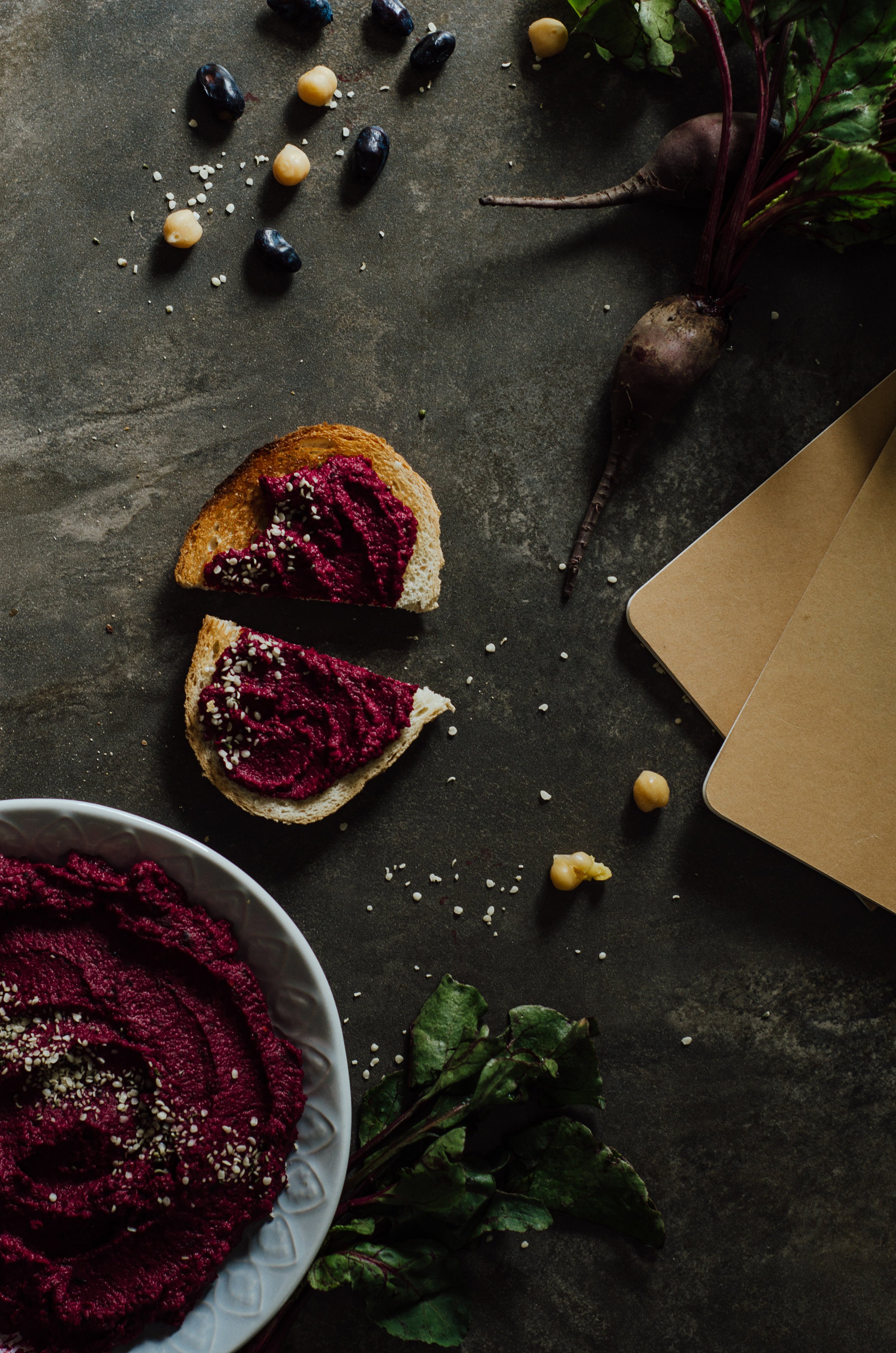  Haskap hummus spread on a slice of toast, sliced in half. 