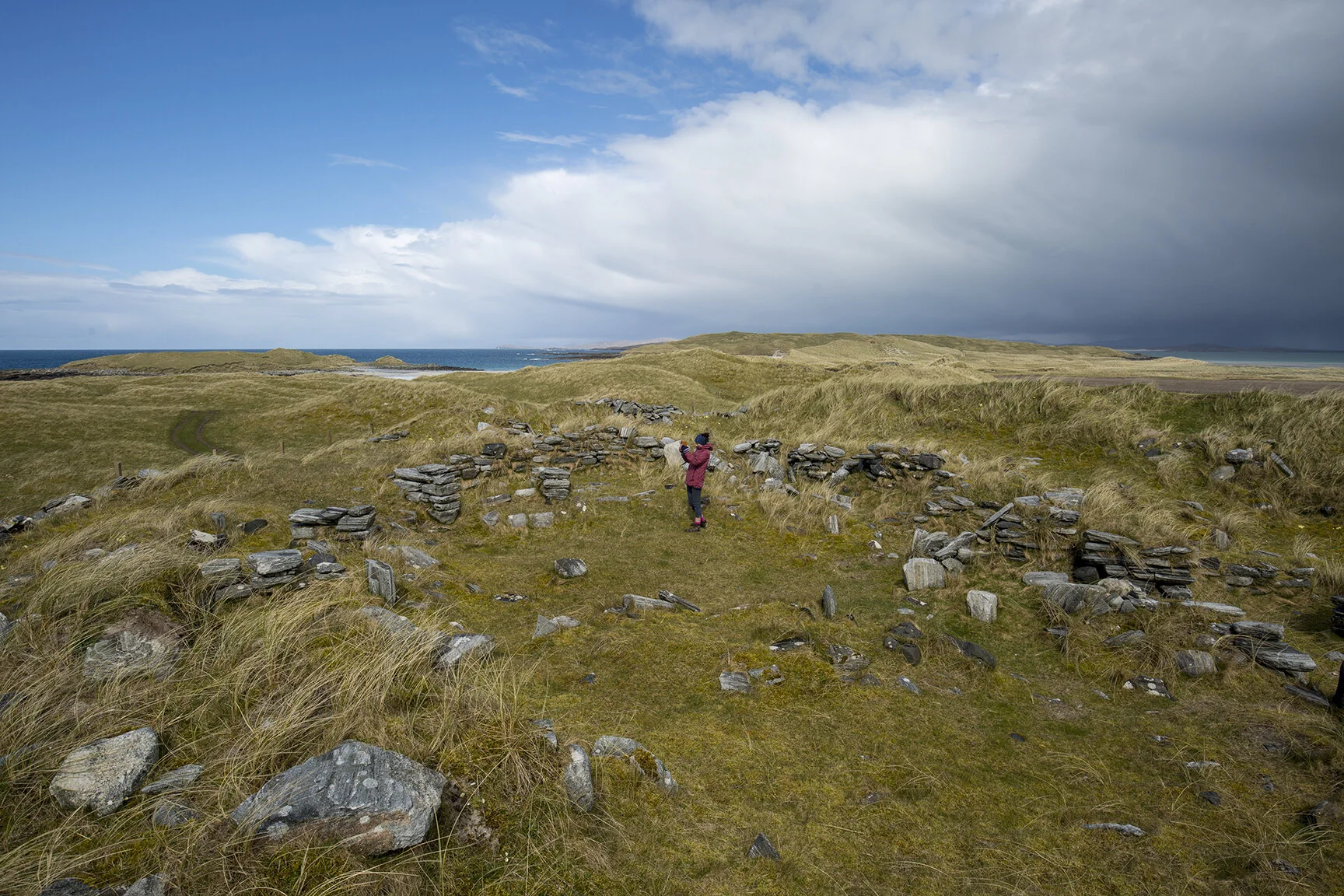 Kate within the wheelhouse archaeological site on Udal peninsula.