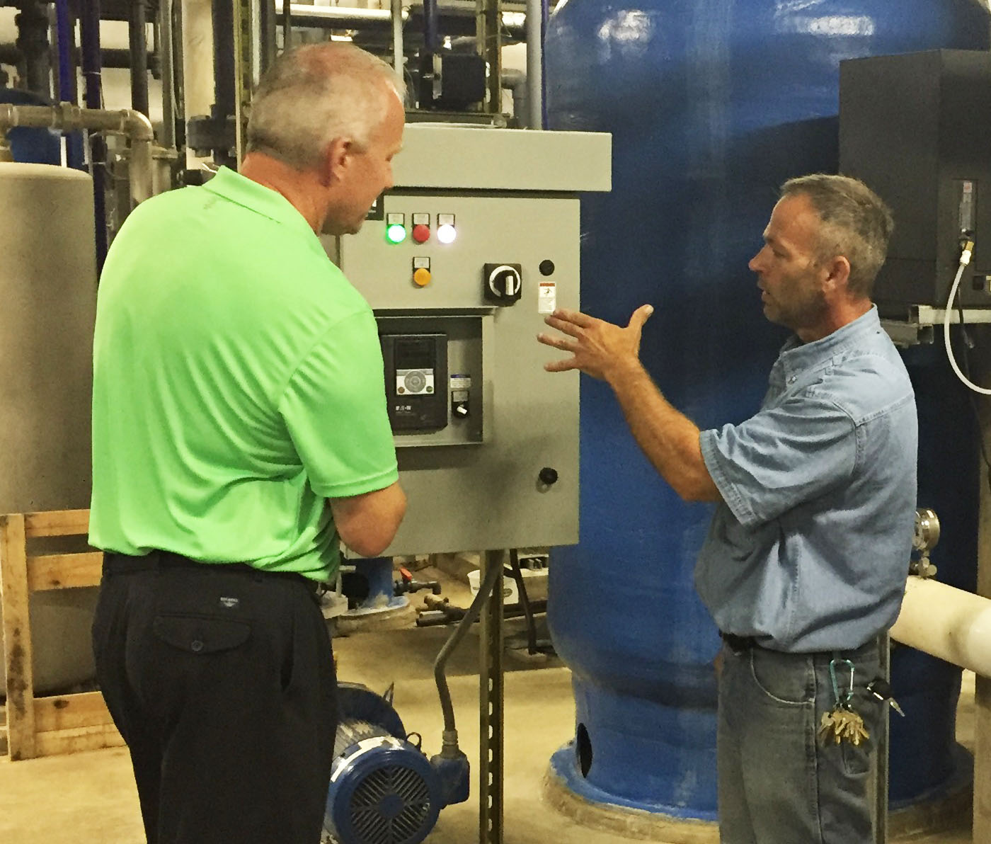 Doug Manders, Account Manager, discussing the Eaton VFD with Facilities Manager John Oglesby.
