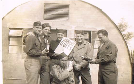 Tom and his military mates celebrate Germany quitting the war.