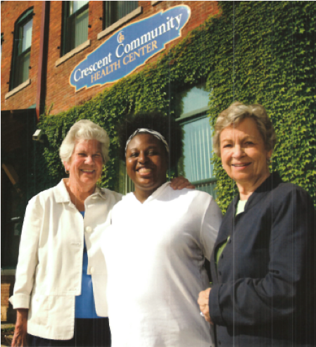 Mary Schmid, Crescent Community Health Center employee, and Janet (Schmid) Rhomberg in front of the Crescent Community Health Center in Dubuque, IA.