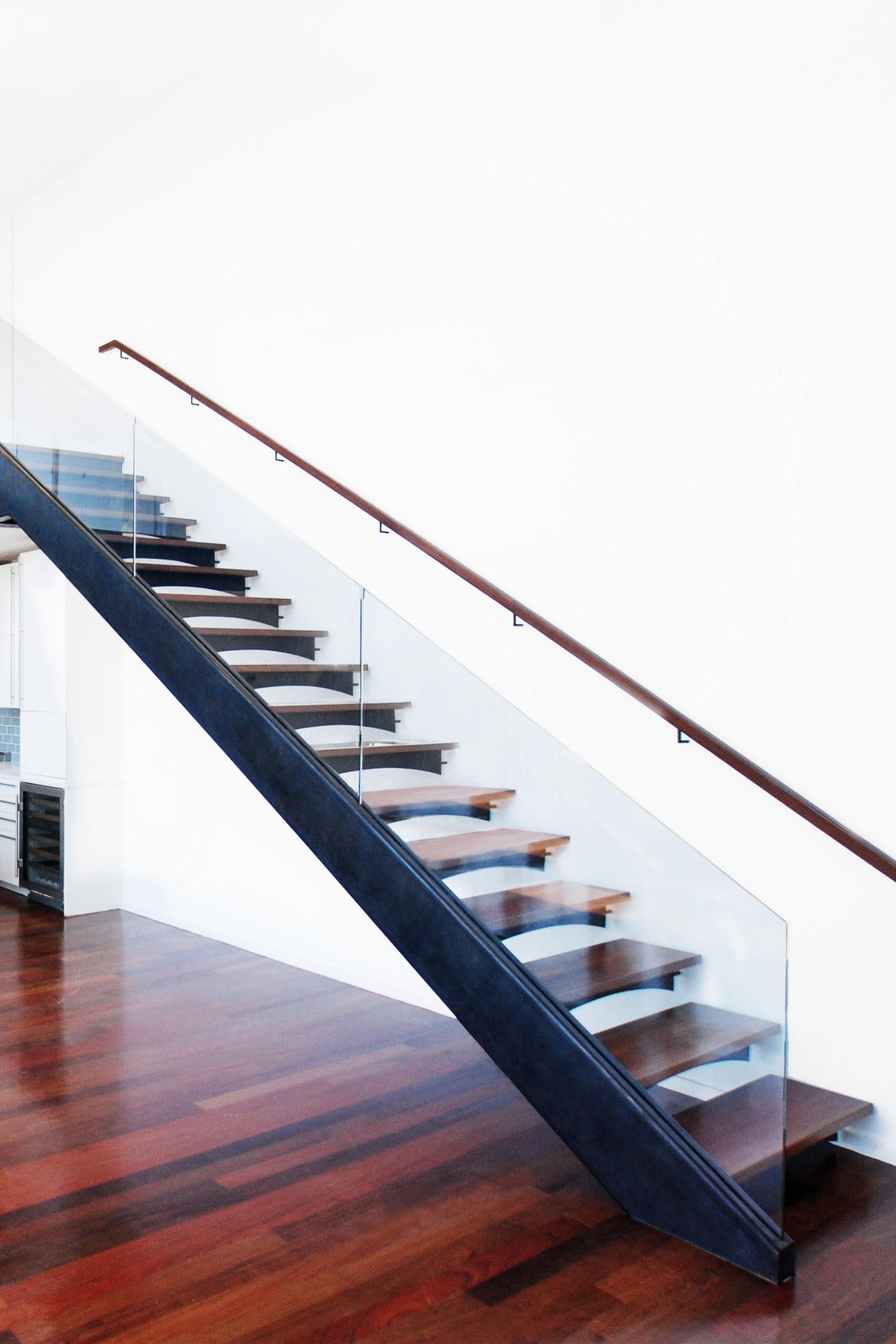 Floating Staircase With Custom Bent Glass