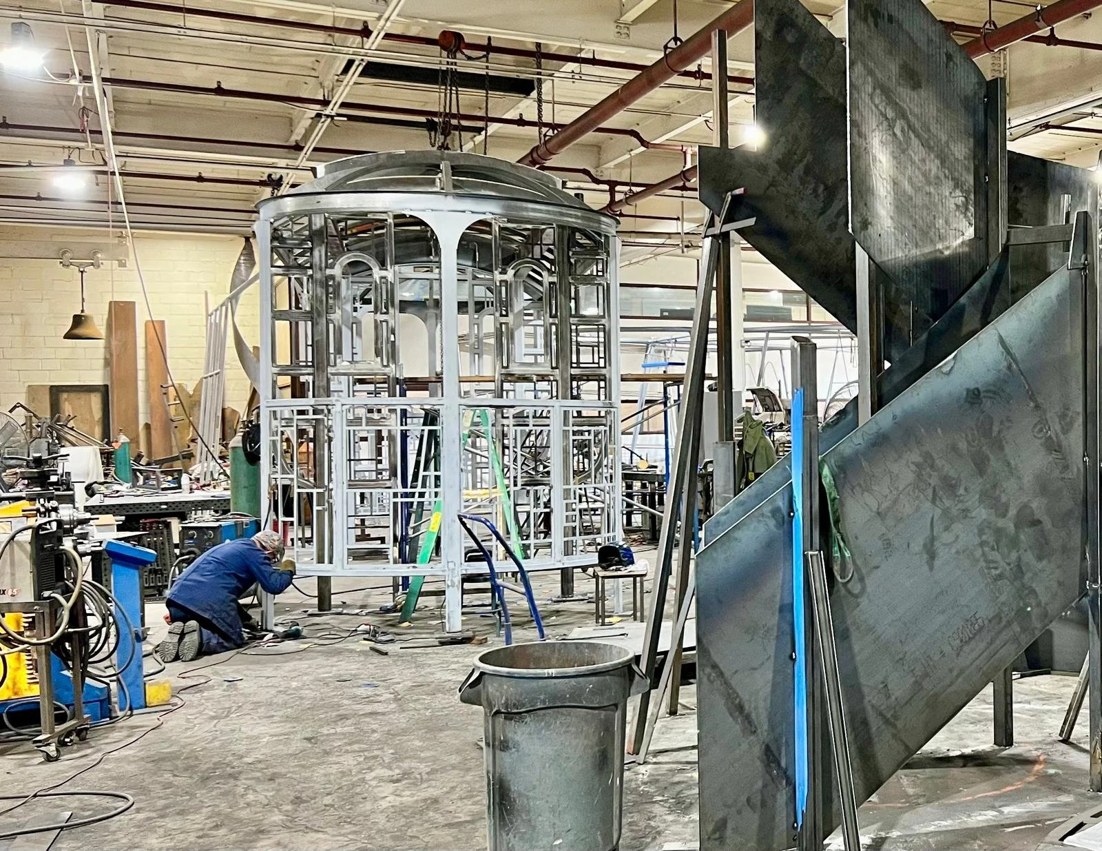 Custom fabricated steel streetcar sculpture in a luxury public plaza