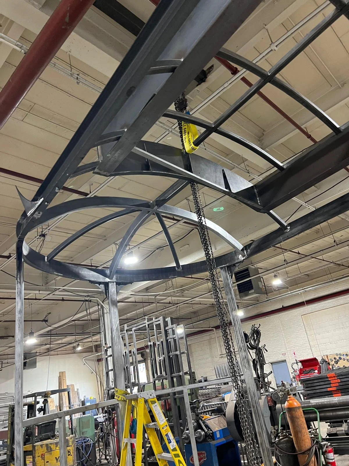 Curved steel roof structure for Tom Fruin Streetcar sculpture during fabrication