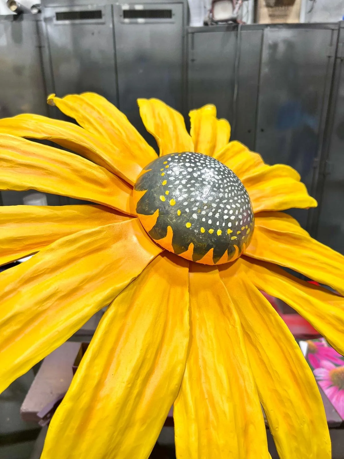 Hand-formed metal flower sculptures before finishing and installation