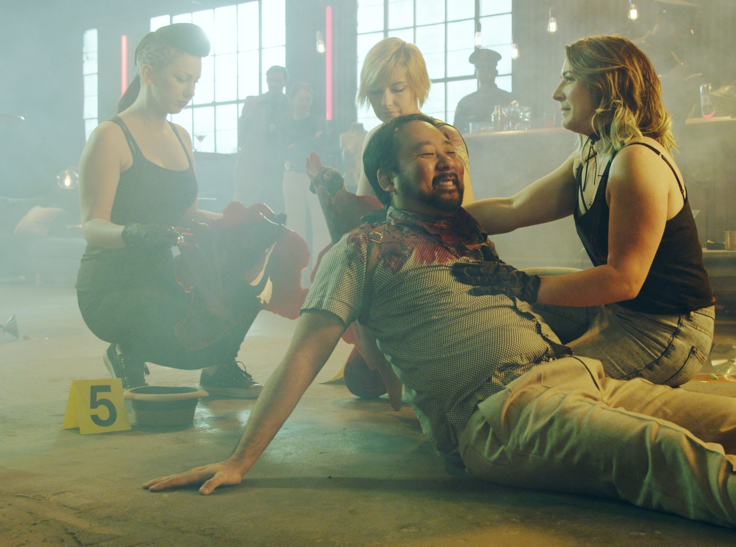 Bloo Rugs Girls switching out a Medium Blood Rug for a Large Blood Rug while holding the roll