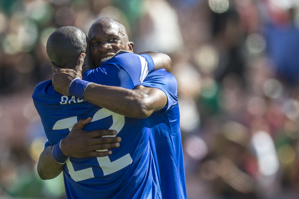 Rabrice Reuperne runs into the arms of teammate Jean-Sylvain Babin after scoring the winning goal in the 93rd minute of Martinique's 1-0 win against Canada in the opening match of the 2013 CONCACAF Gold Cup at the Rose Bowl in Pasadena, Calif., on Sunday, July 7, 2013. (© Fernando J Tirado 2013)