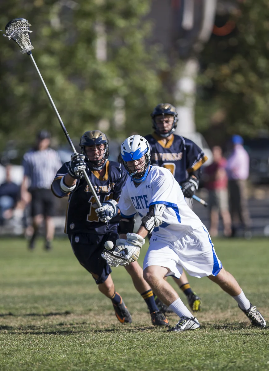 A Cate School Boy's Varsity Lacrosse player juggles the ball as his Dos Pueblos opponents give chase during the Cate School's 17-2 win at the Cate School in Carpinteria, Calif. on Thursday, March 26 2015. (© Fernando J Tirado 2015)