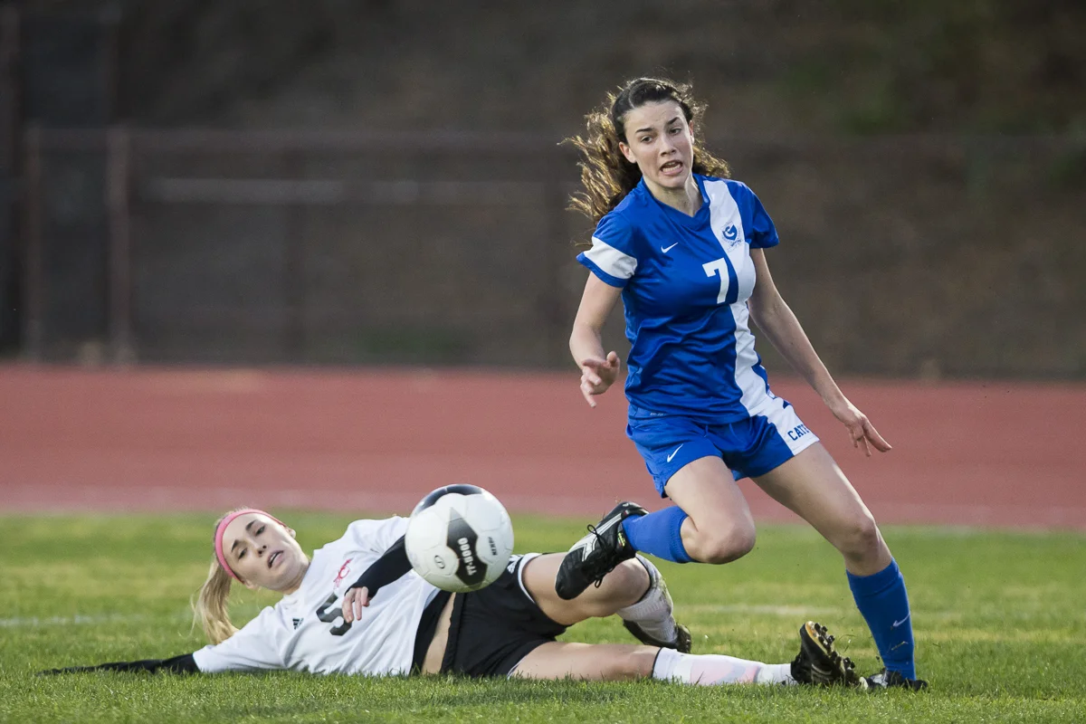 Anna Graves escapes a slide tackle from her Carpinteria High School opponent during the Cate School's 6-1 loss on Thursday, January 15th 2015 at the Cate School in Carpinteria, Calif. (© Fernando J Tirado 2015)