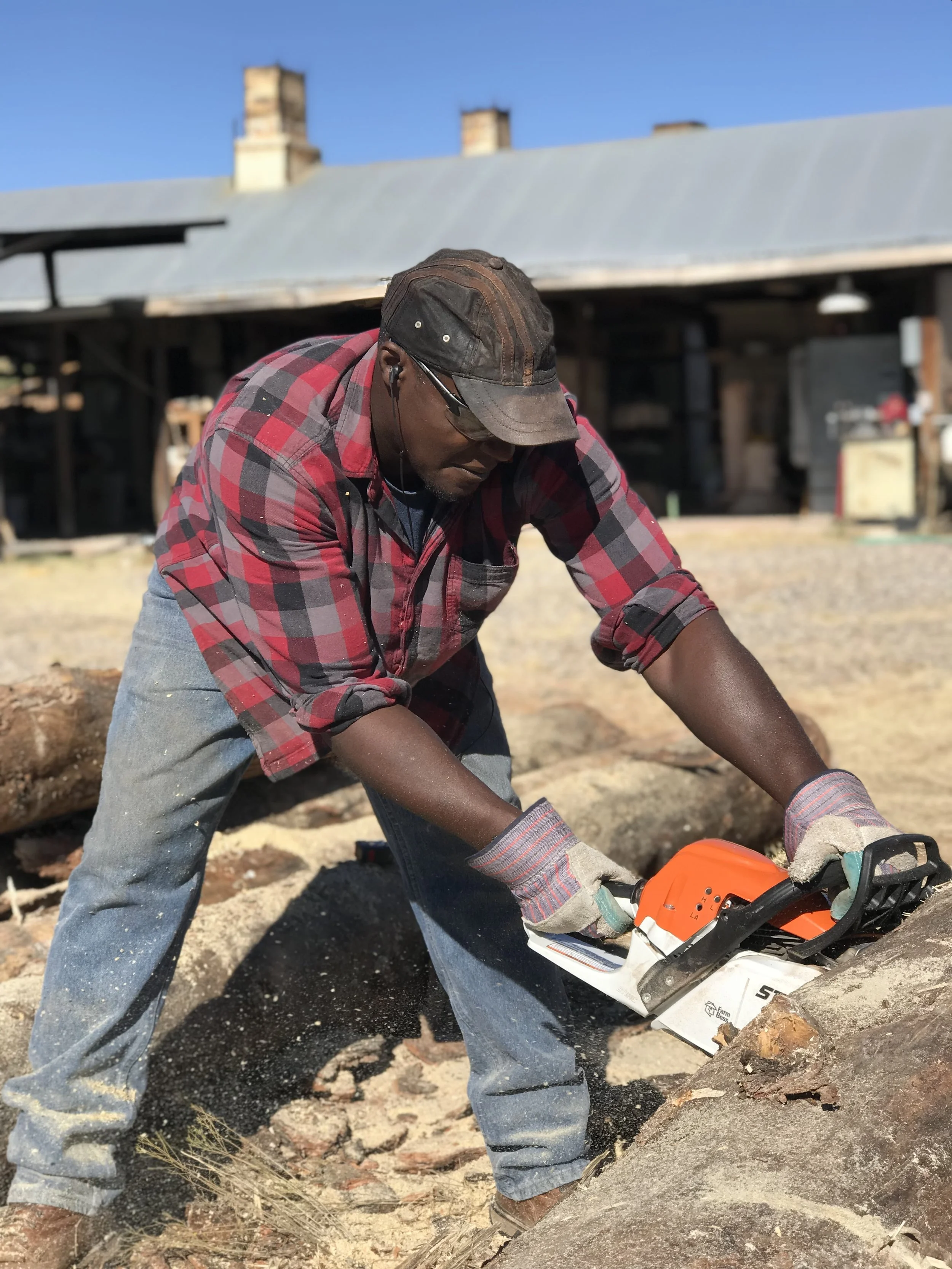 Dexter Woods sawing the logs