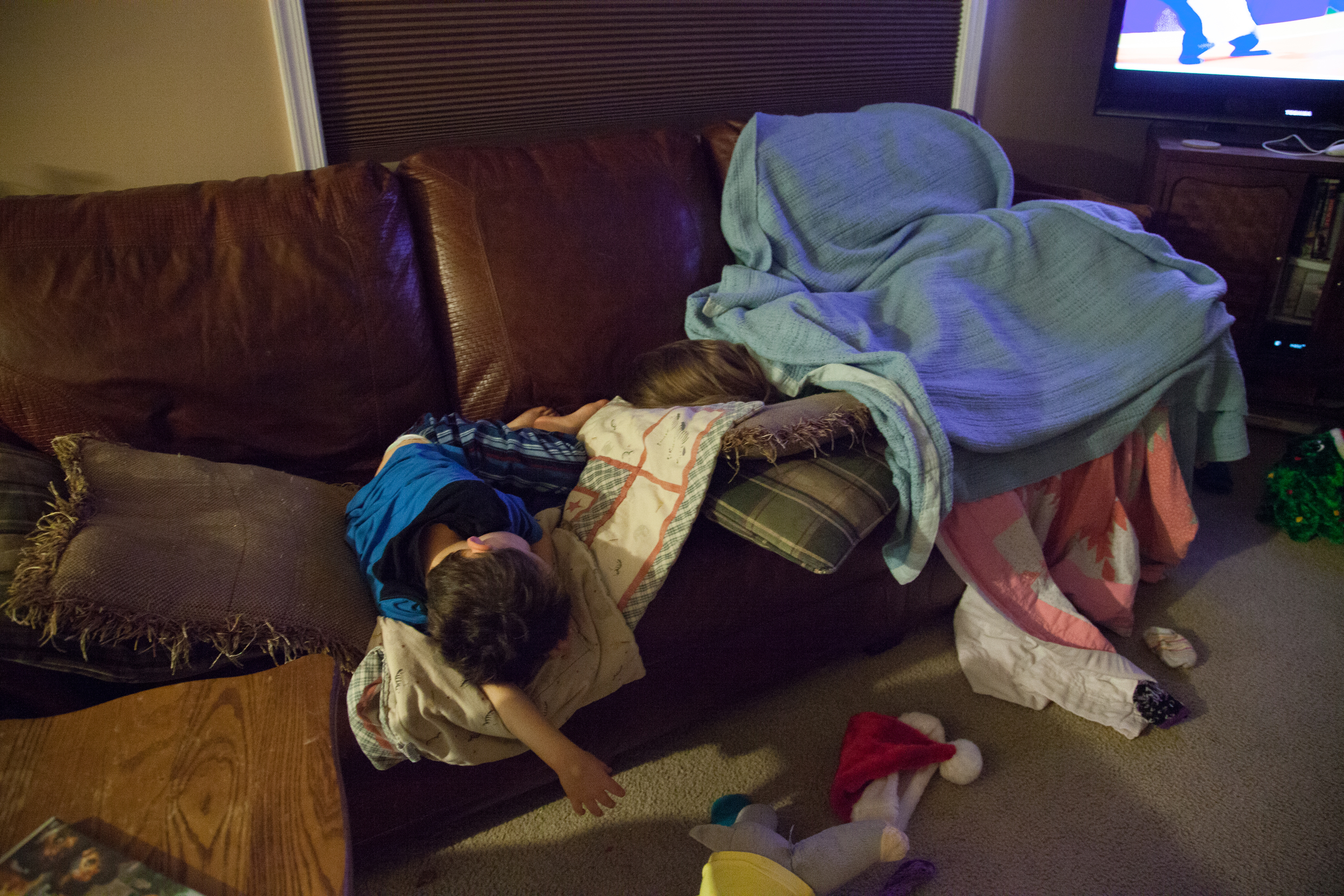 Dillon Kelly, 4, and Robin Kelly, 8, lay passed out on the couch after a Chinese buffet dinner at their home in Hagerstown, M.D. on Dec. 6, 2015. 