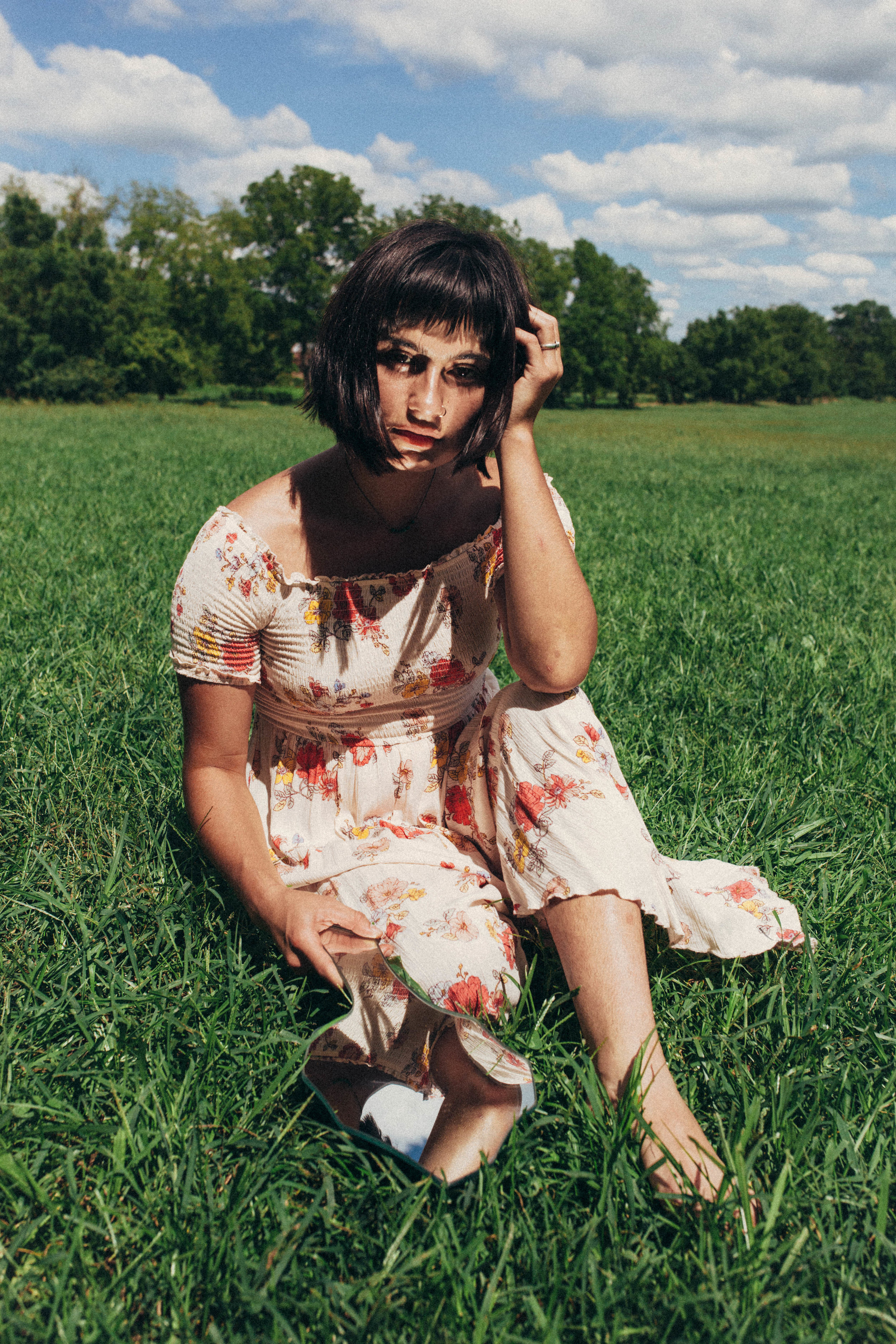 surreal portrait of a girl in a long dress in the grass