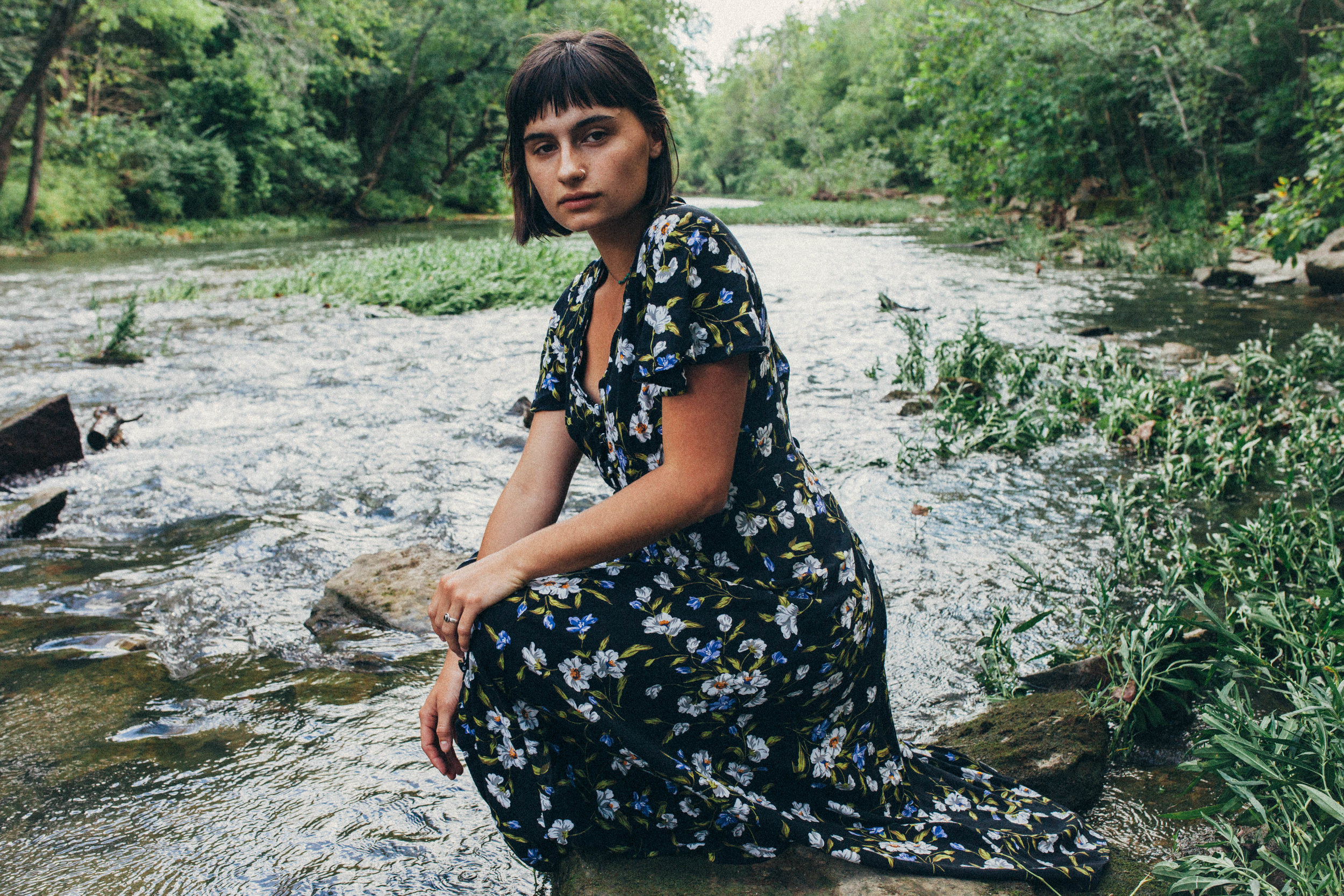 Missouri editorial session. portrait of a dark haired girl in a flowy dress in the river in 