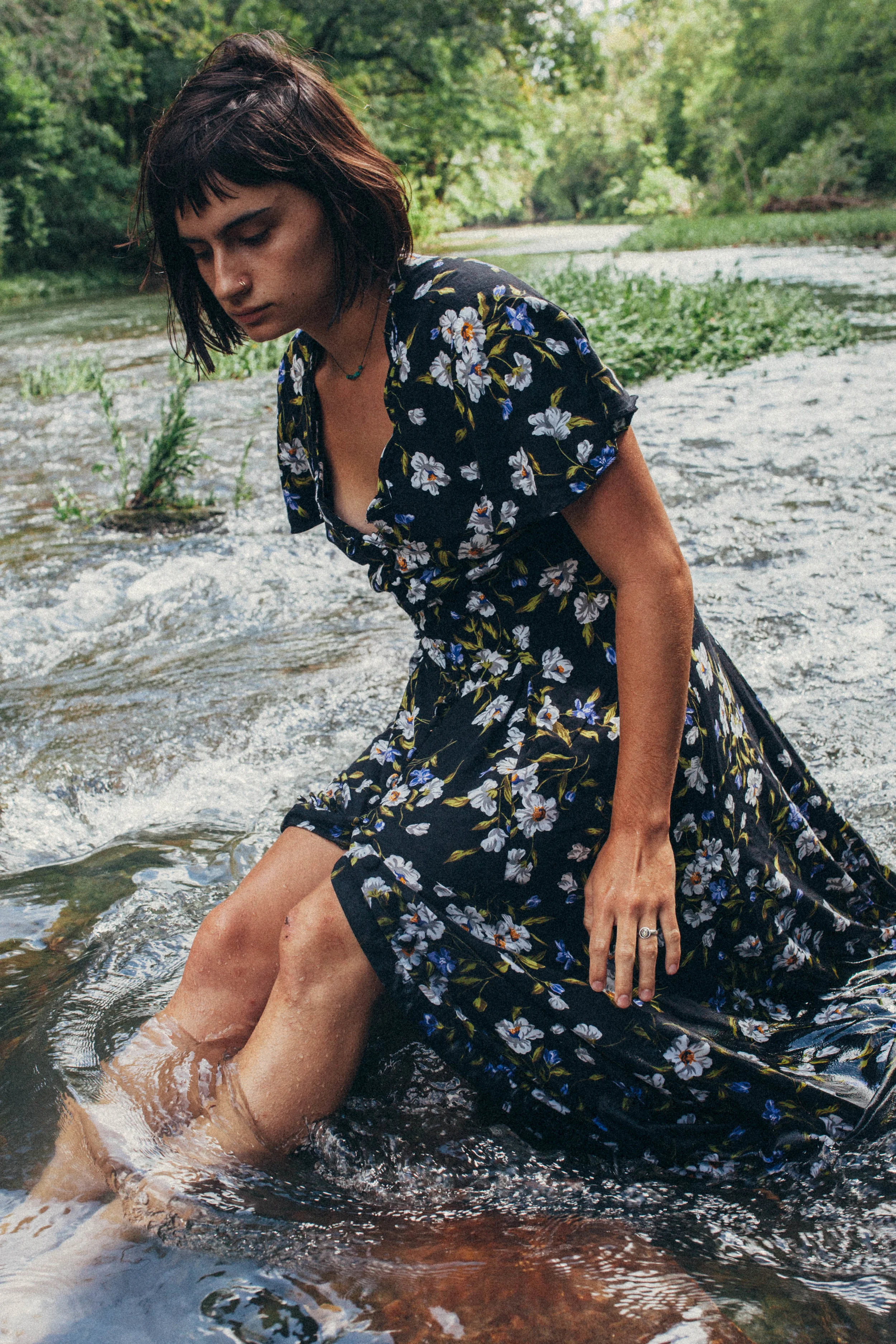 Missouri editorial session. portrait of a dark haired girl in a flowy dress in the river in
